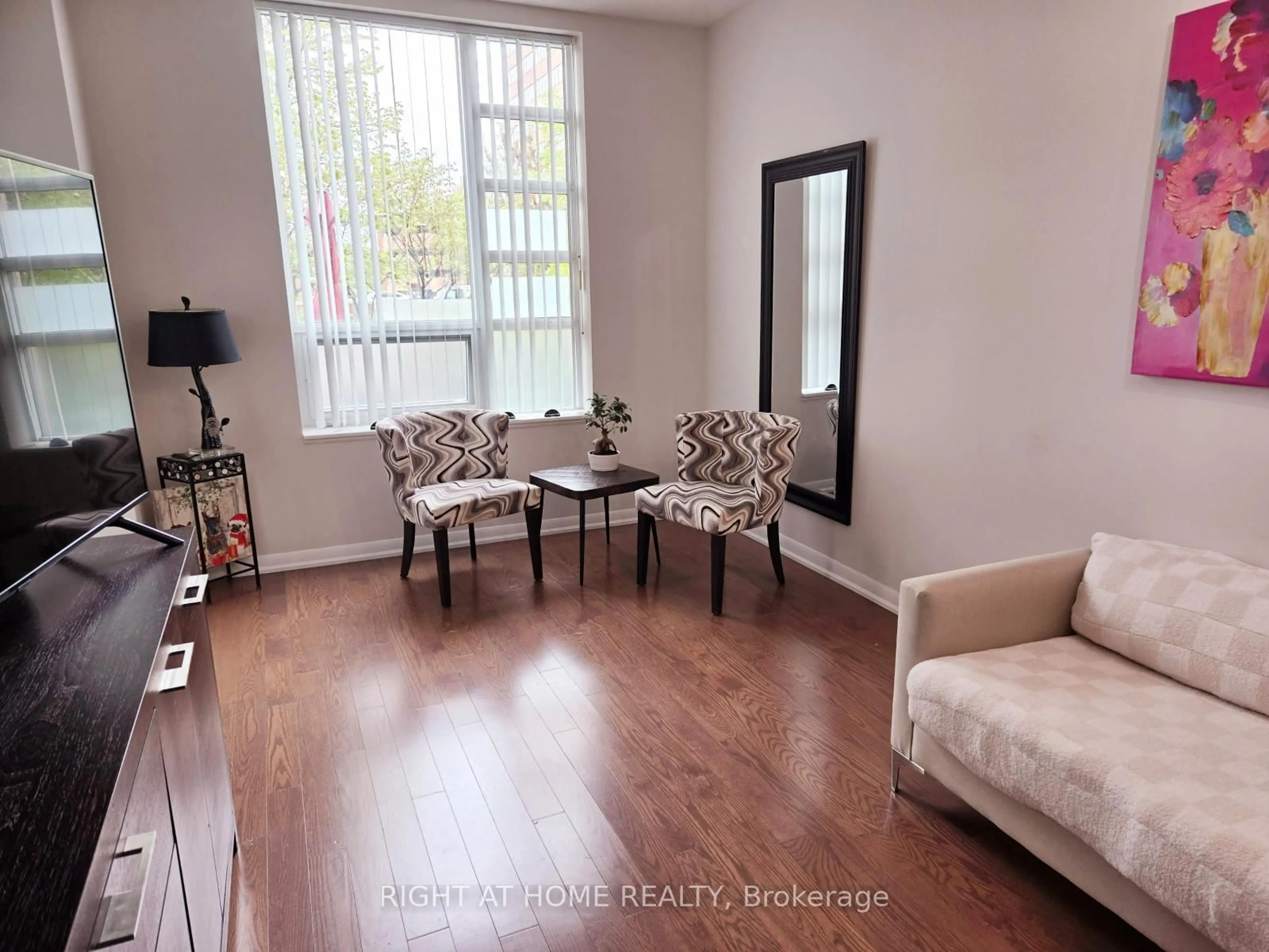 Living room with furniture, wood/laminate floor for 215 Sherway Gardens Rd #101, Toronto Ontario M9C 0A4