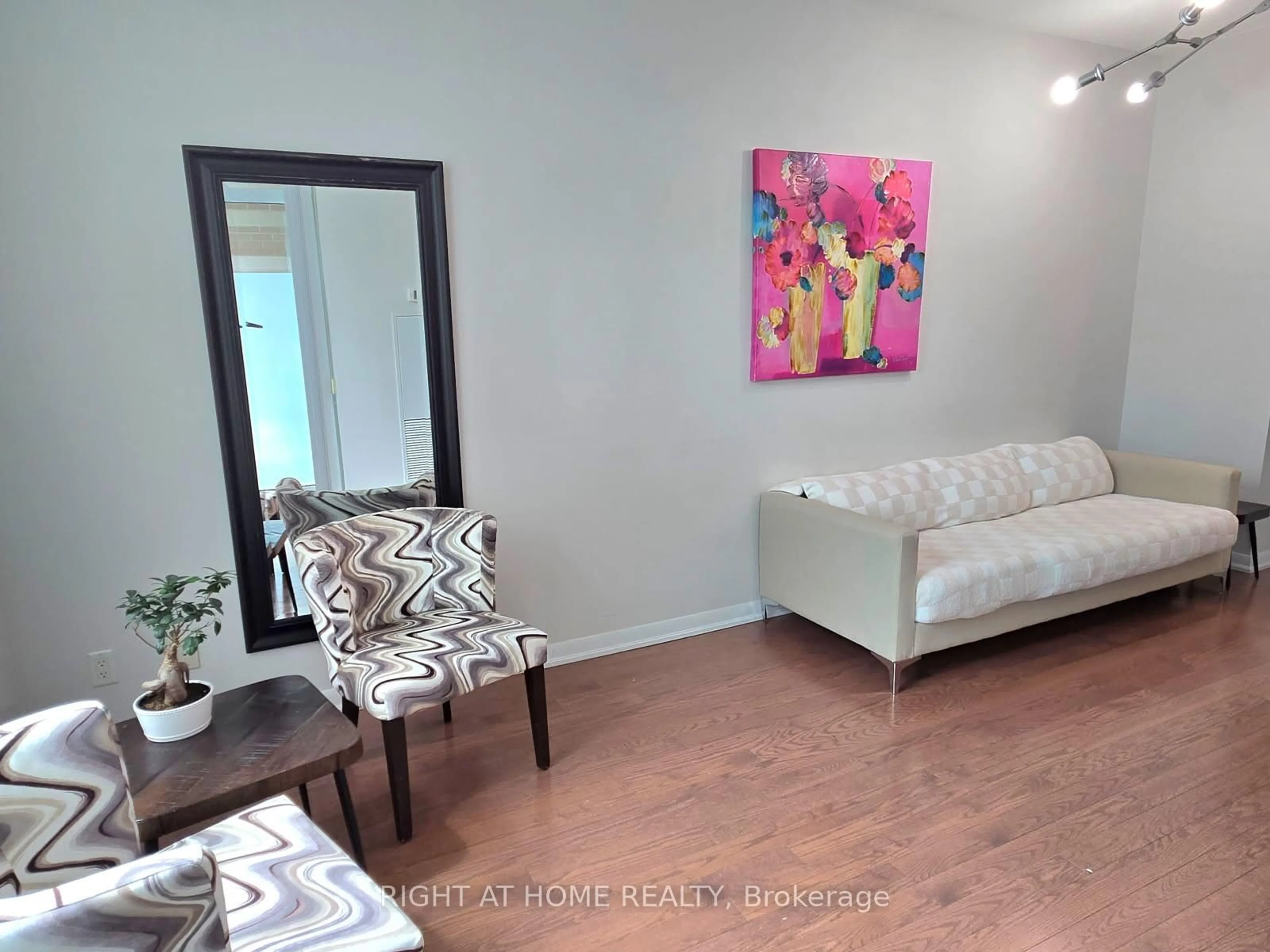 Living room with furniture, wood/laminate floor for 215 Sherway Gardens Rd #101, Toronto Ontario M9C 0A4