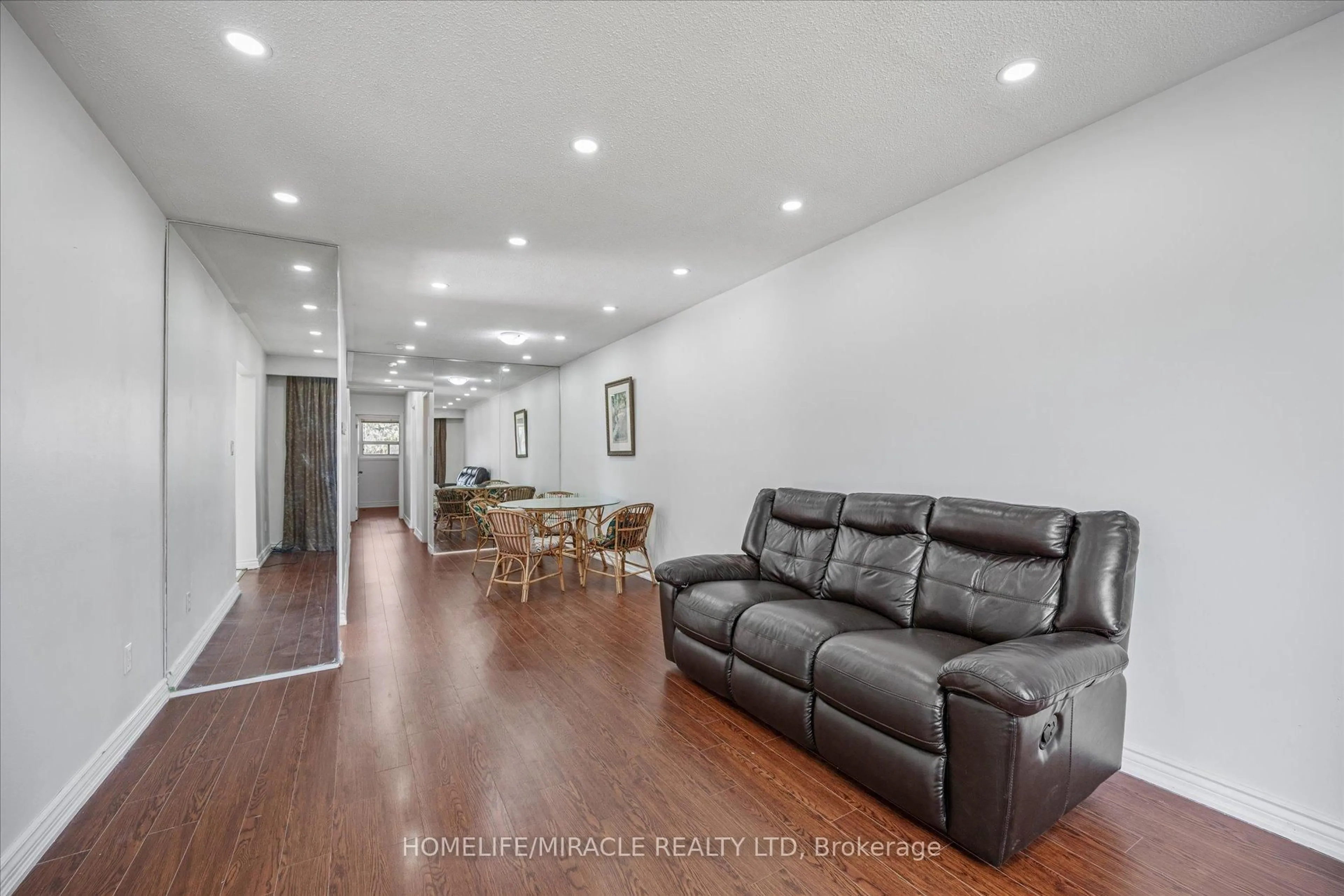 Living room with furniture, wood/laminate floor for 77 Juniper Cres, Brampton Ontario L6S 1J9