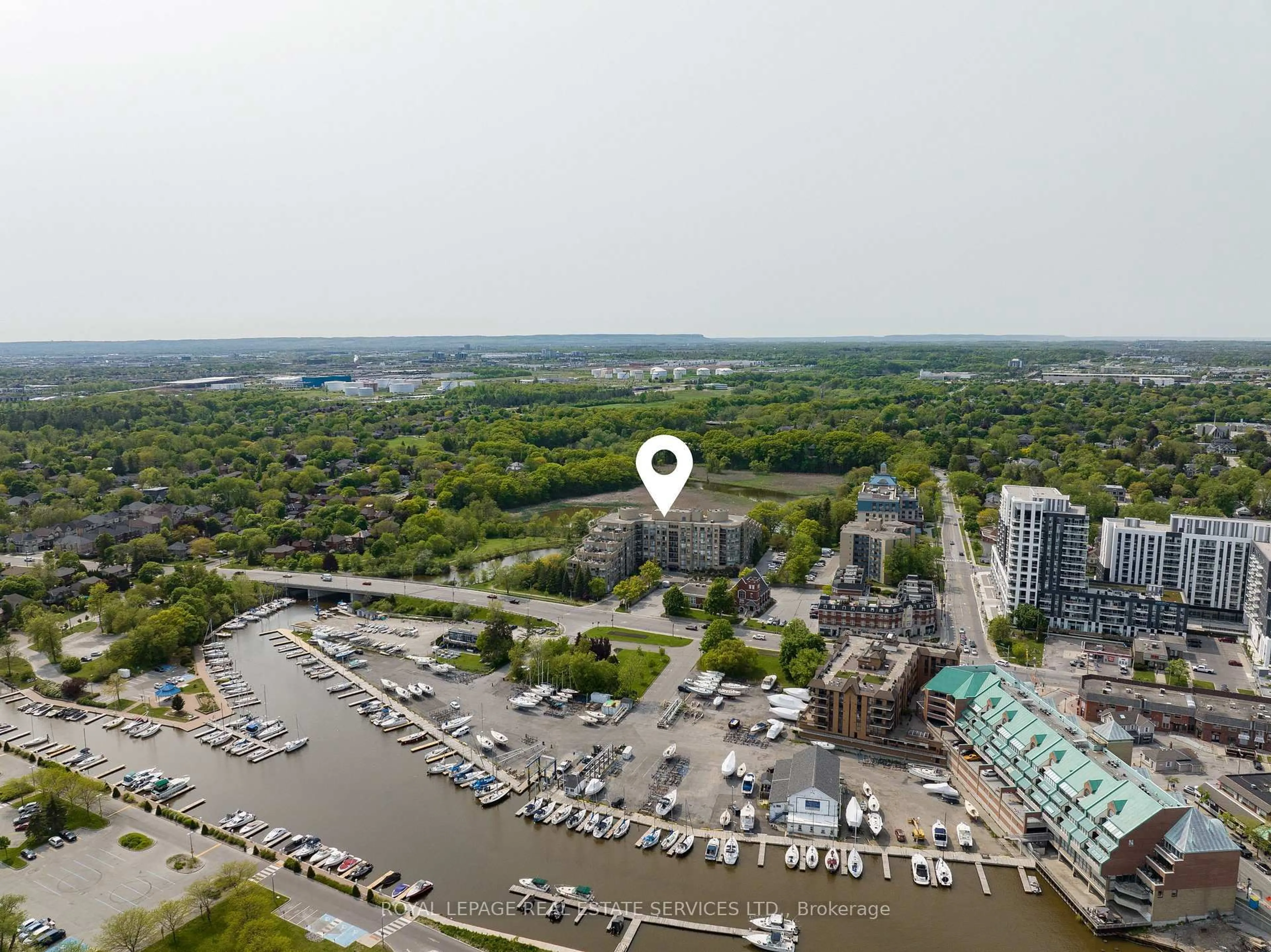 A pic from outside/outdoor area/front of a property/back of a property/a pic from drone, water/lake/river/ocean view for 2511 Lakeshore Rd #214, Oakville Ontario L6L 6L9
