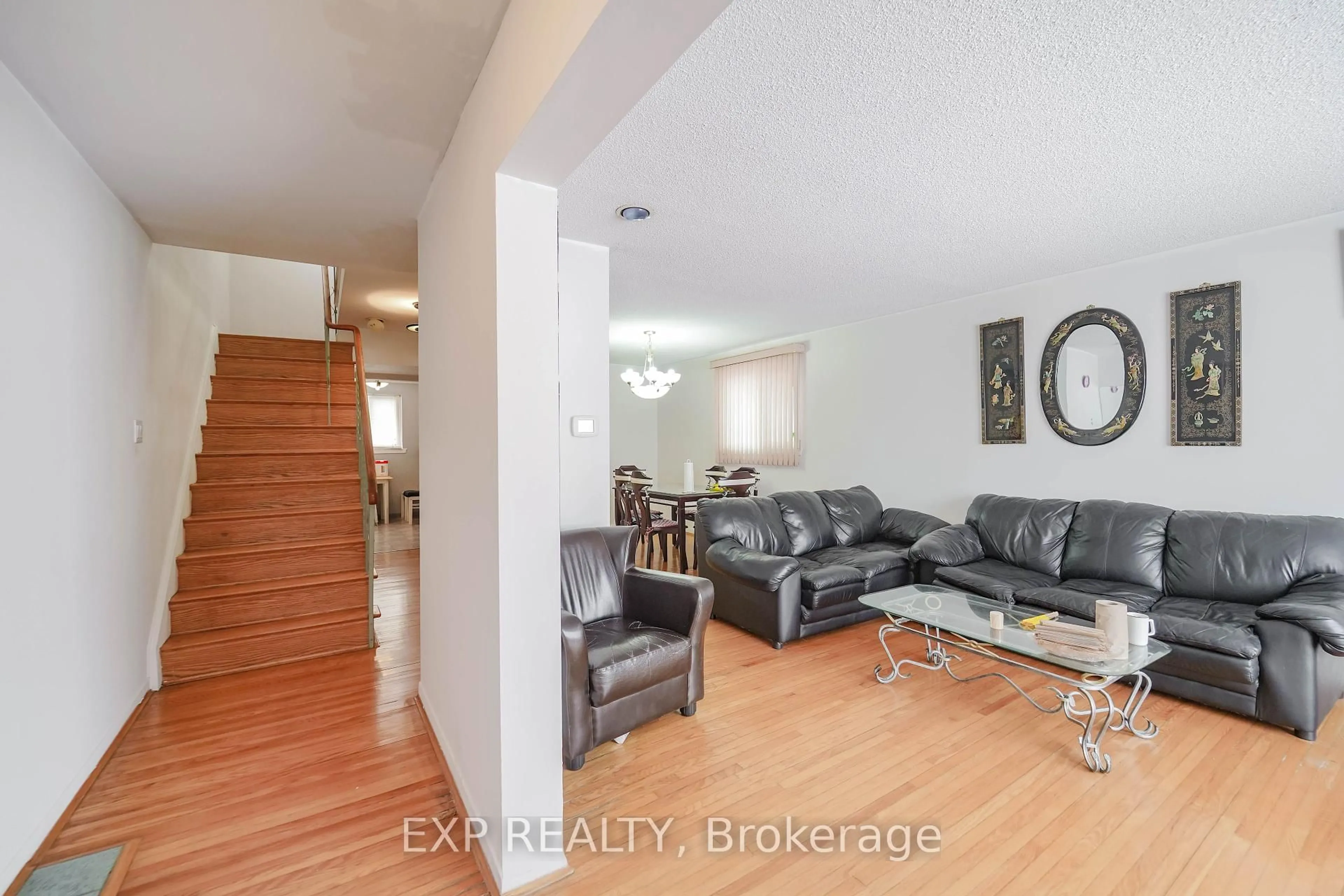Living room with furniture, wood/laminate floor for 23 Cloverdale Dr, Brampton Ontario L6T 2T5
