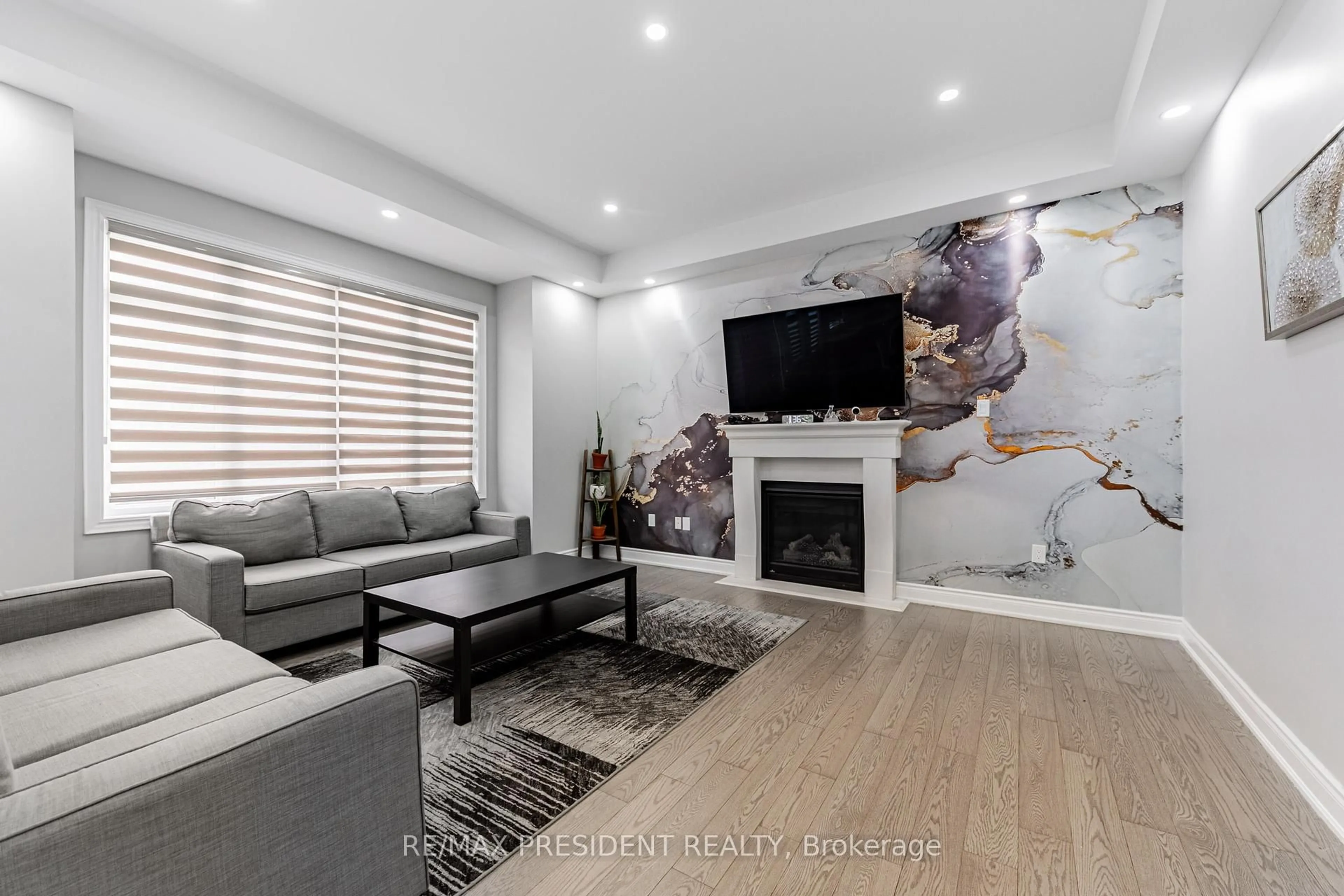 Living room with furniture, wood/laminate floor for 32 Elderbridge Rd, Brampton Ontario L6P 4G5