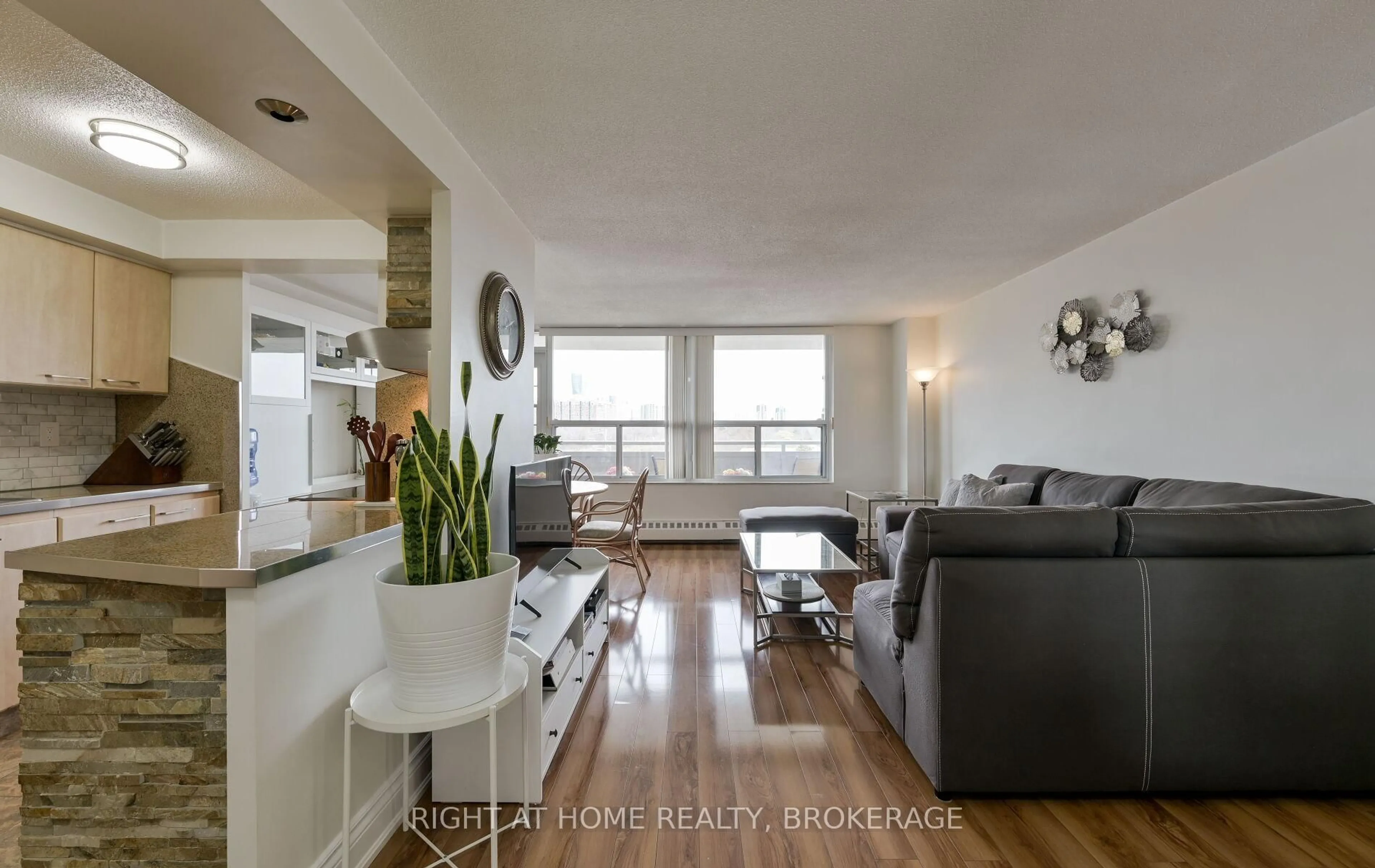 Living room with furniture, wood/laminate floor for 3120 Kirwin Ave #607, Mississauga Ontario L5A 3R2