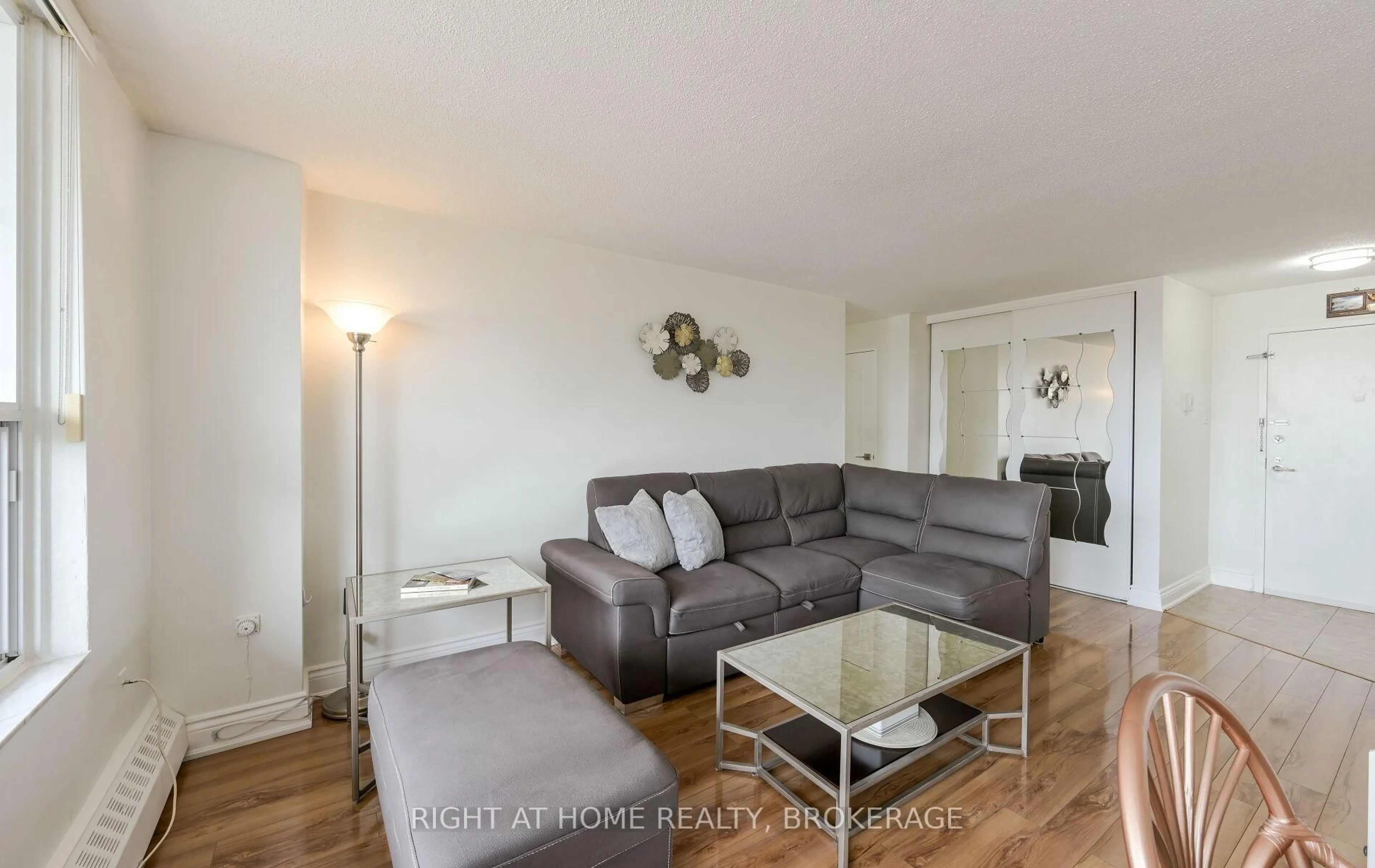 Living room with furniture, wood/laminate floor for 3120 Kirwin Ave #607, Mississauga Ontario L5A 3R2