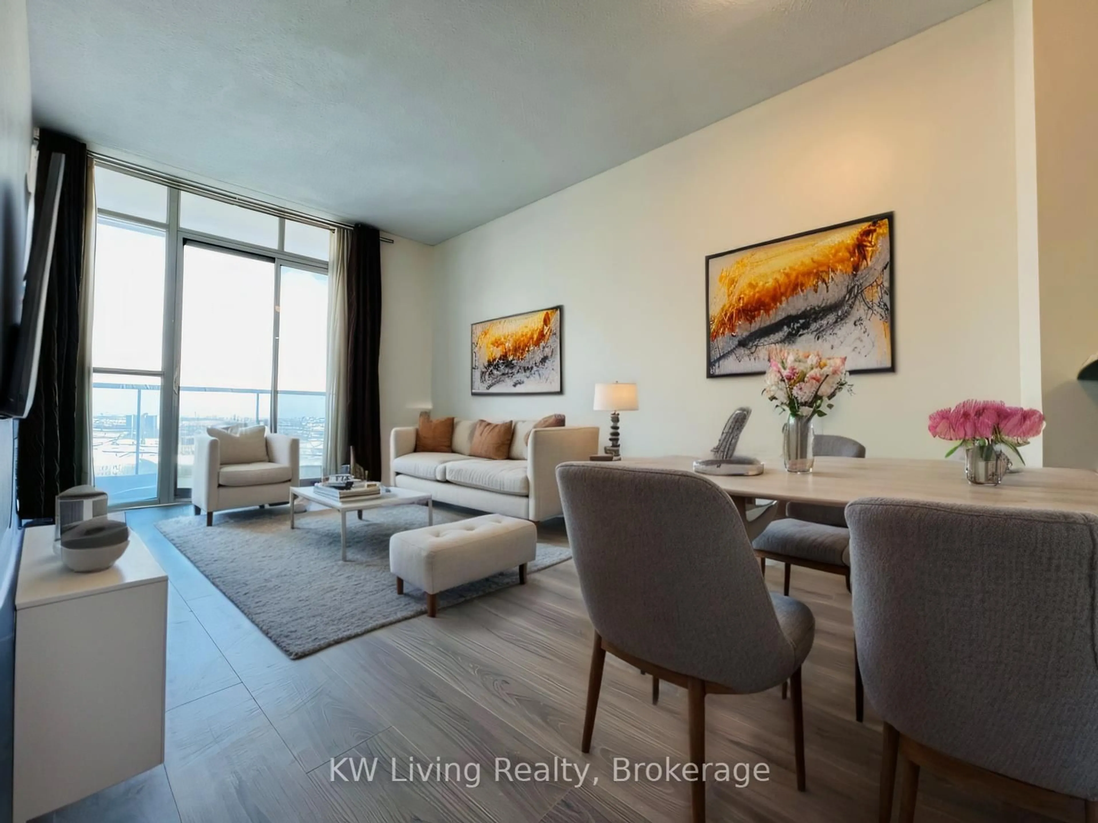 Living room with furniture, wood/laminate floor for 80 Absolute Ave #1201, Mississauga Ontario L4Z 0A5