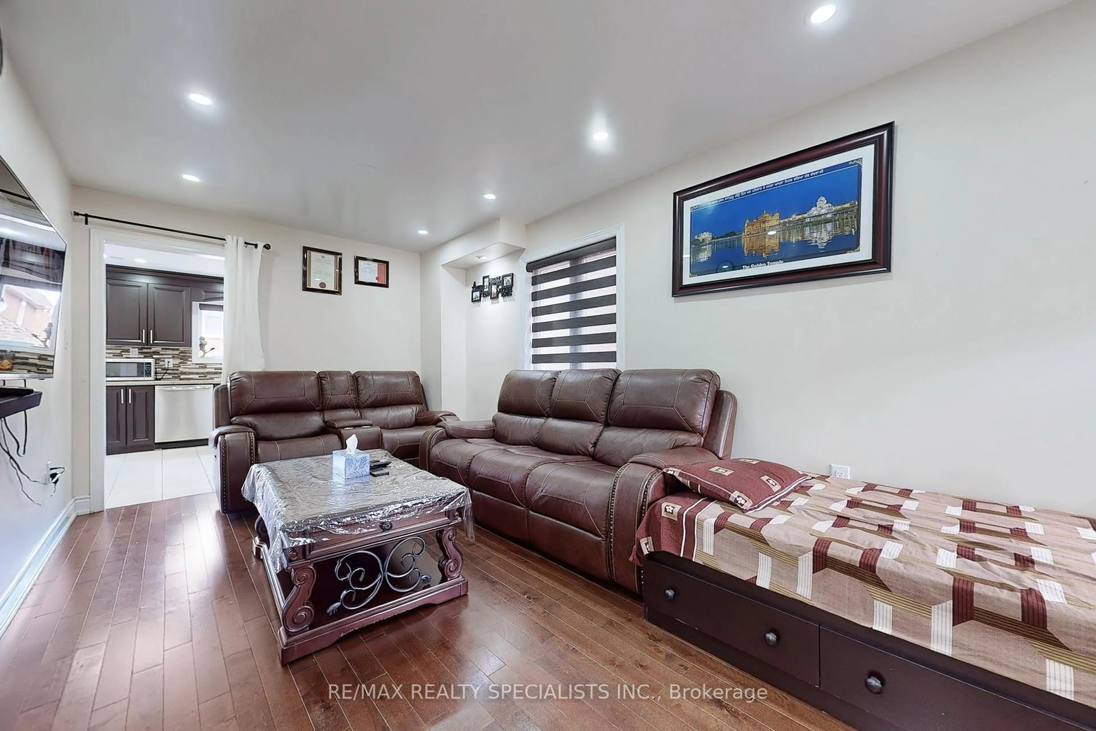 Living room with furniture, wood/laminate floor for 53 Coachwhip Rd, Brampton Ontario L6R 1X9