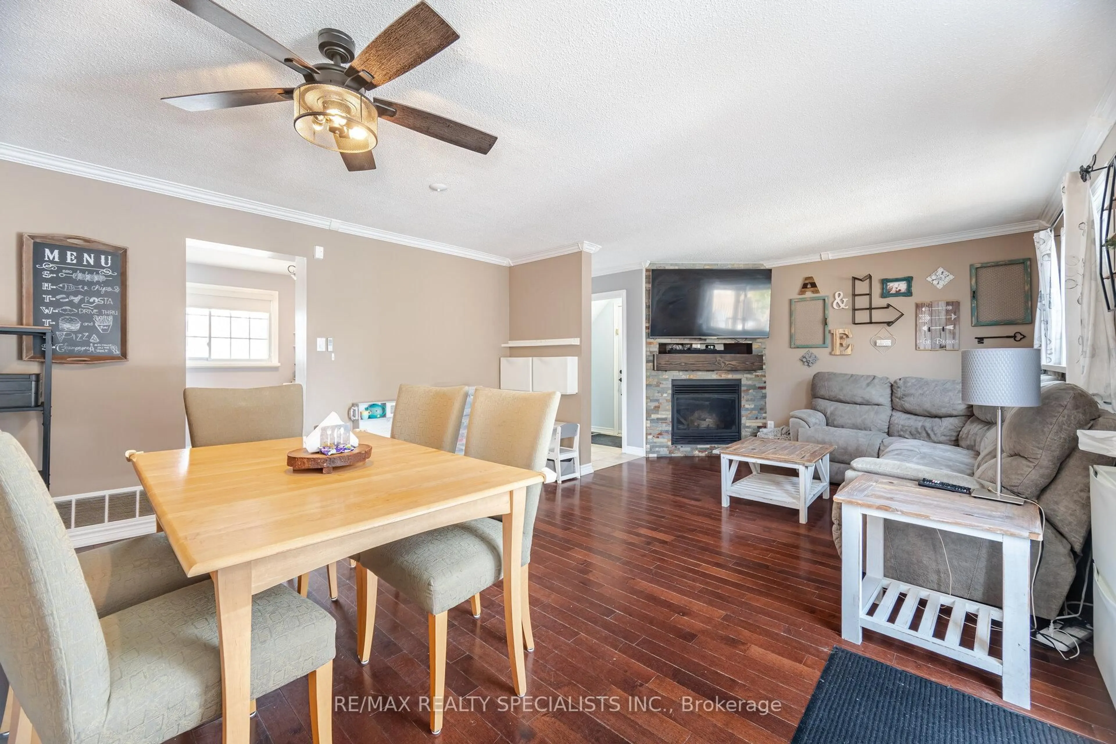 Living room with furniture, wood/laminate floor for 65 Charters Rd, Brampton Ontario L6V 2S8