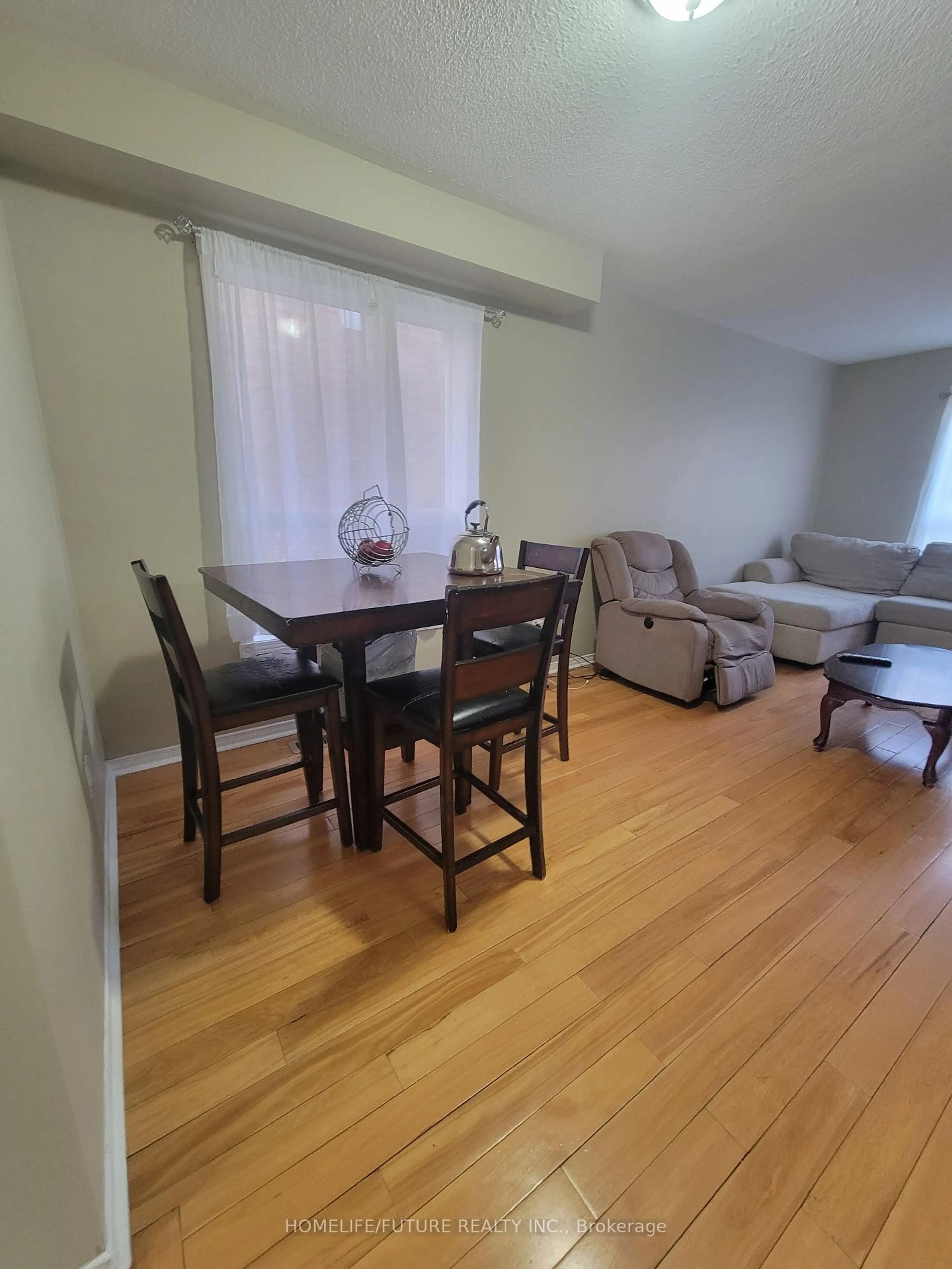 Living room with furniture, wood/laminate floor for 14 Peachleaf Cres, Brampton Ontario L7A 2B2