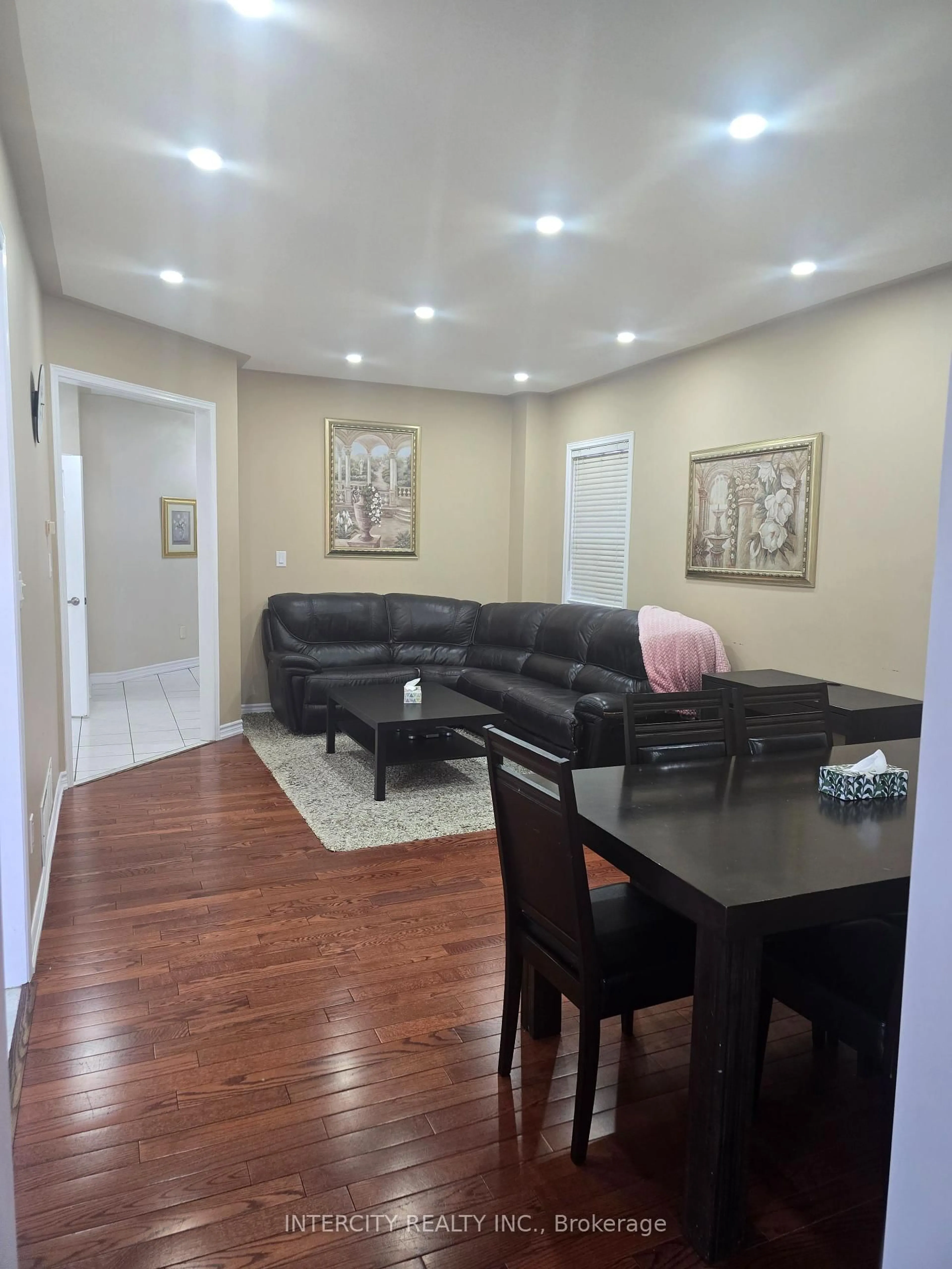 Living room with furniture, wood/laminate floor for 27 ZIA DODDA Cres, Brampton Ontario L6P 1J6