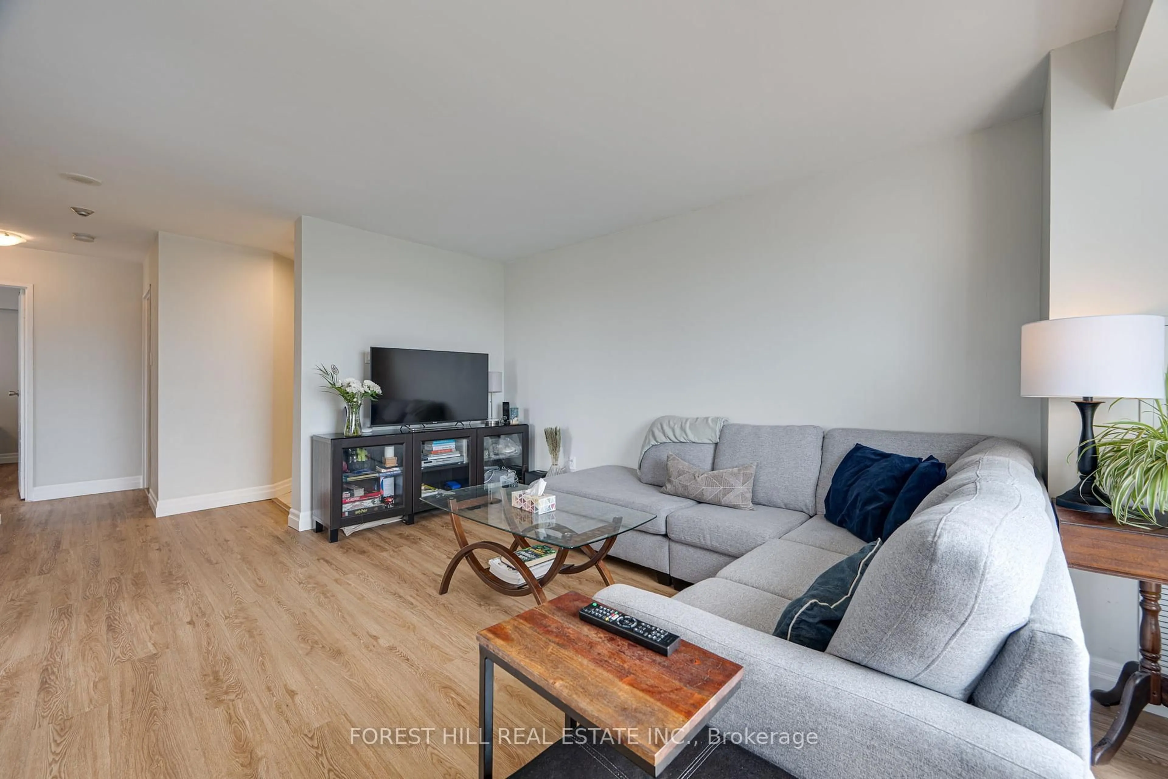 Living room with furniture, wood/laminate floor for 3077 Weston Rd #609, Toronto Ontario M9M 3A1