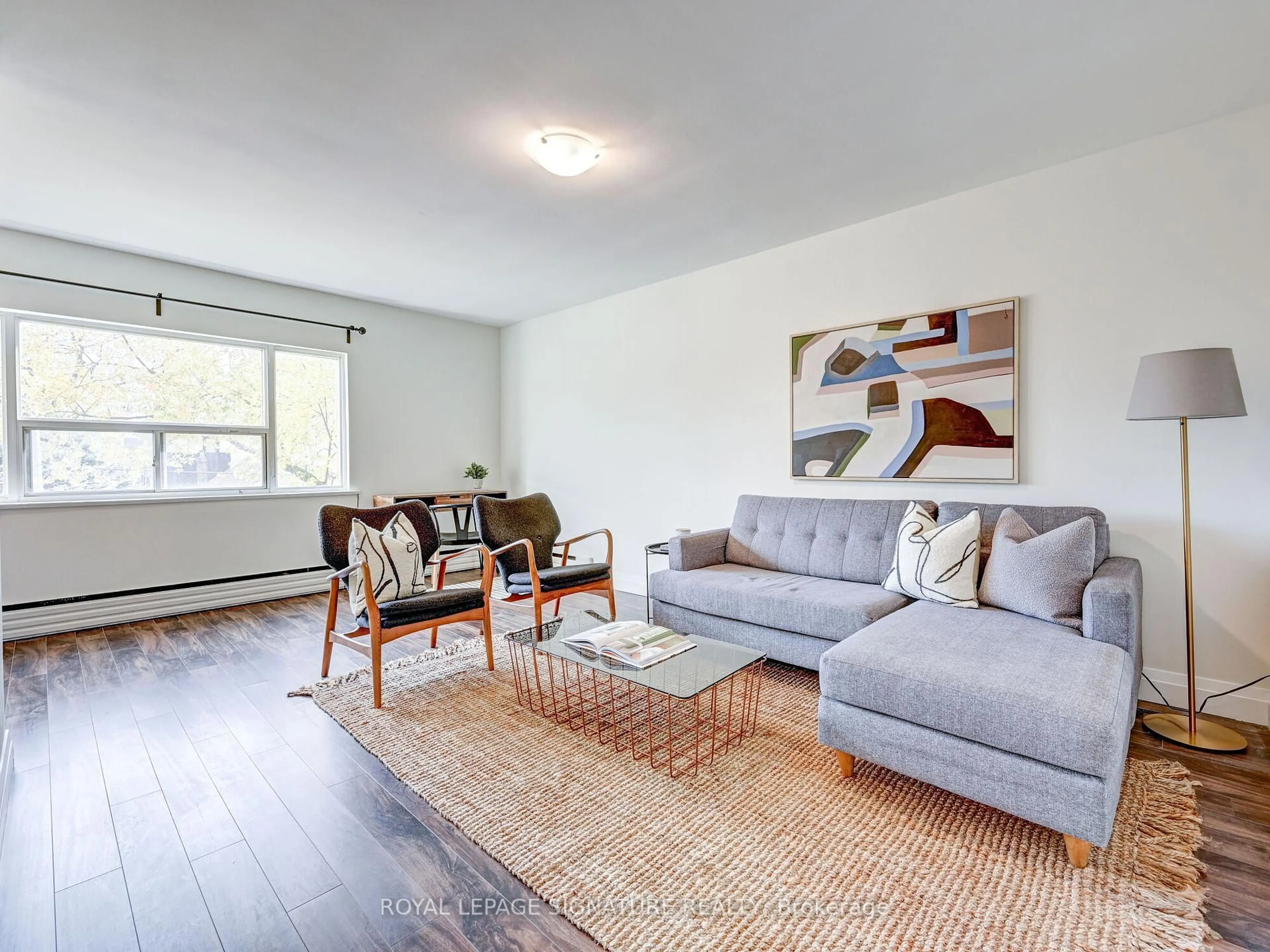 Living room with furniture, wood/laminate floor for 40 Cavell Ave, Toronto Ontario M8V 1P2