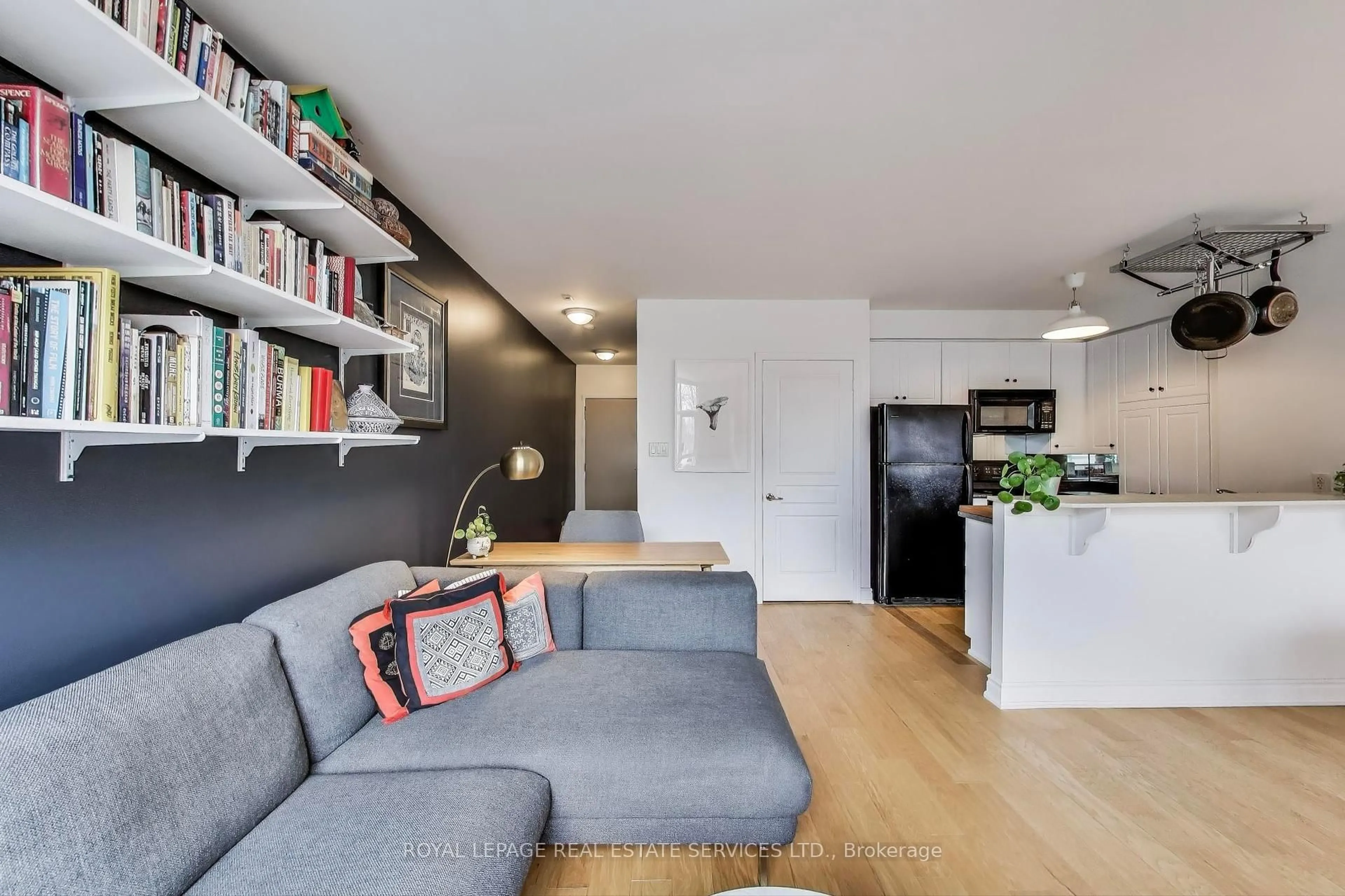 Living room with furniture, wood/laminate floor for 2495 Dundas St #201, Toronto Ontario M6P 1X4