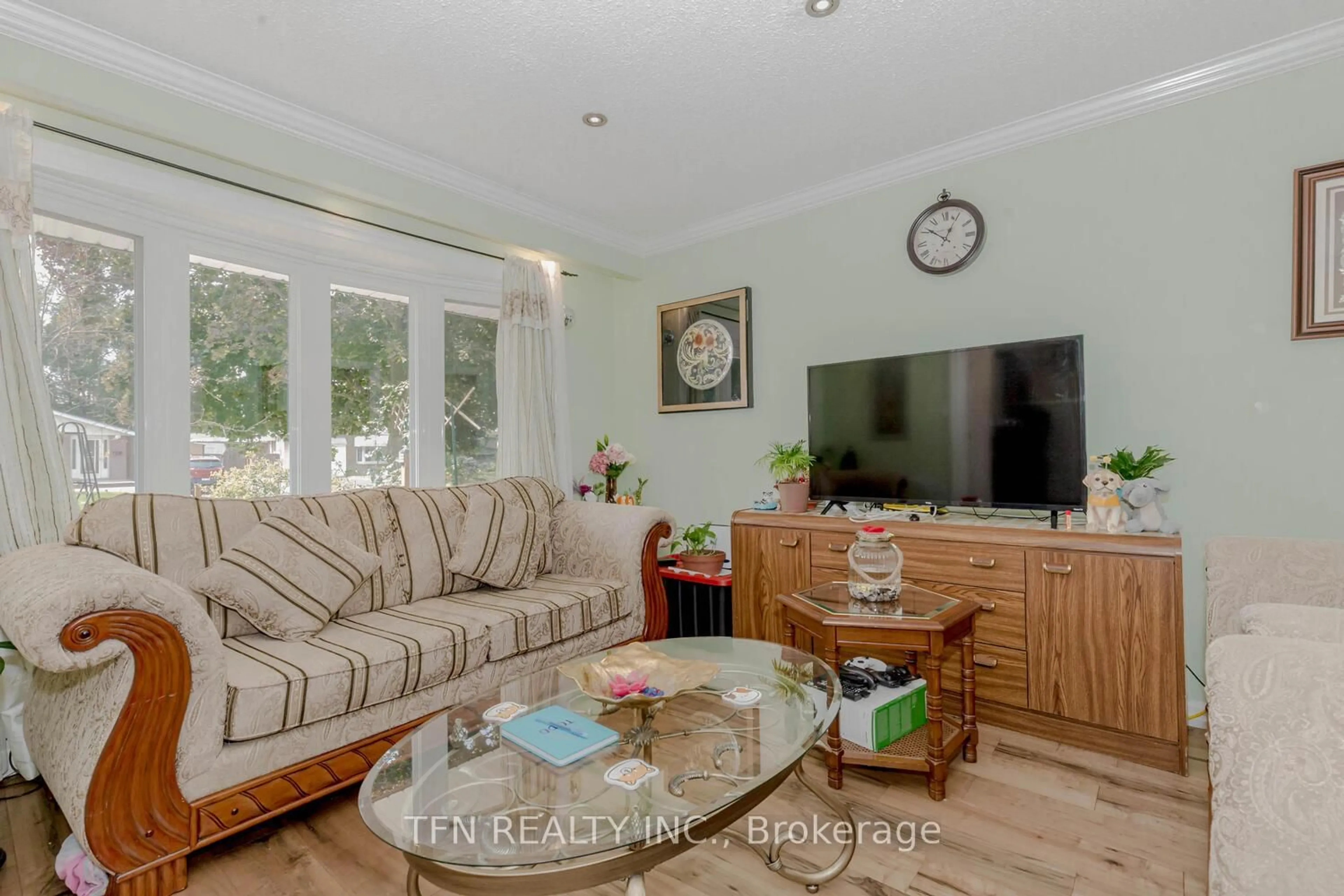 Living room with furniture, wood/laminate floor for 11 Glenmore Cres, Brampton Ontario L6S 1H9