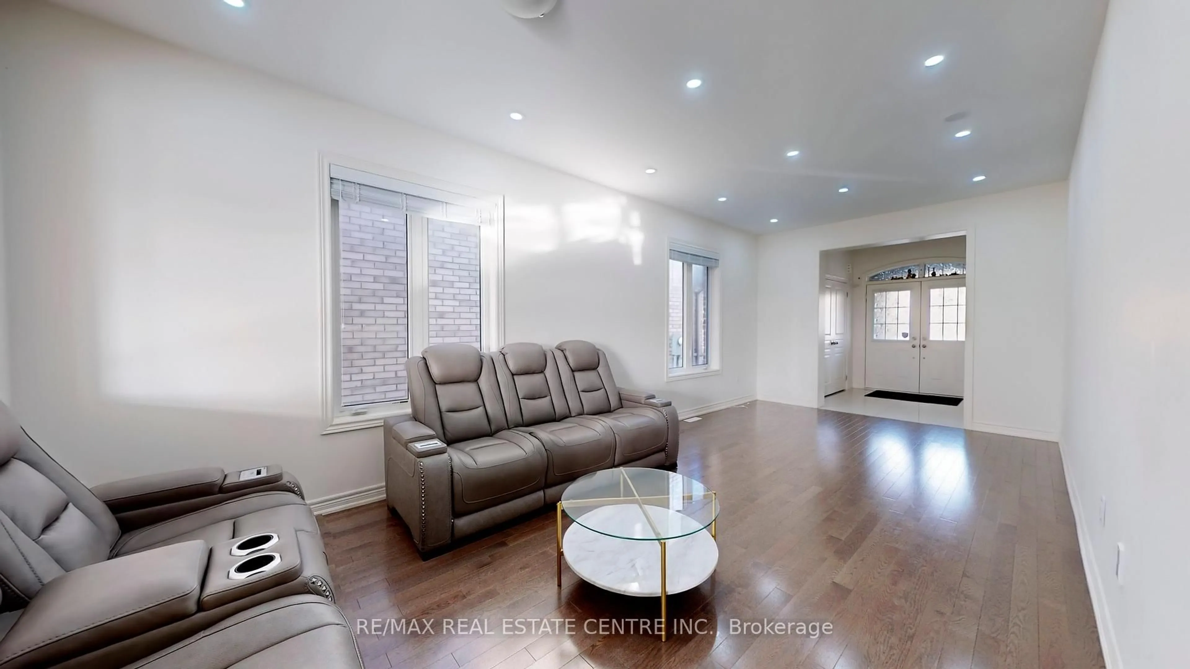Living room with furniture, wood/laminate floor for 16 O'connor Cres, Brampton Ontario L7A 5A6