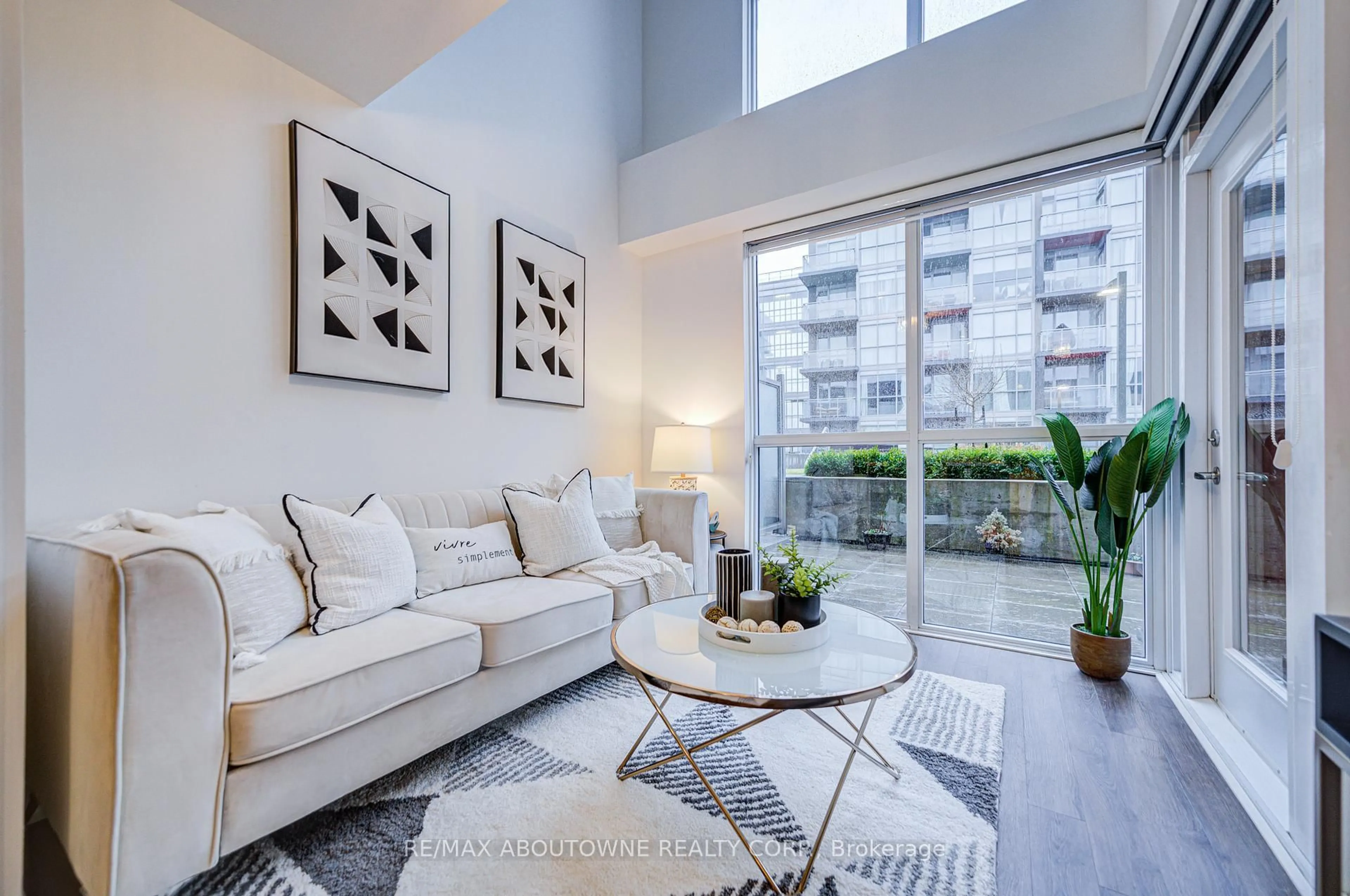 Living room with furniture, unknown for 5260 Dundas St #C202, Burlington Ontario L7R 0J7