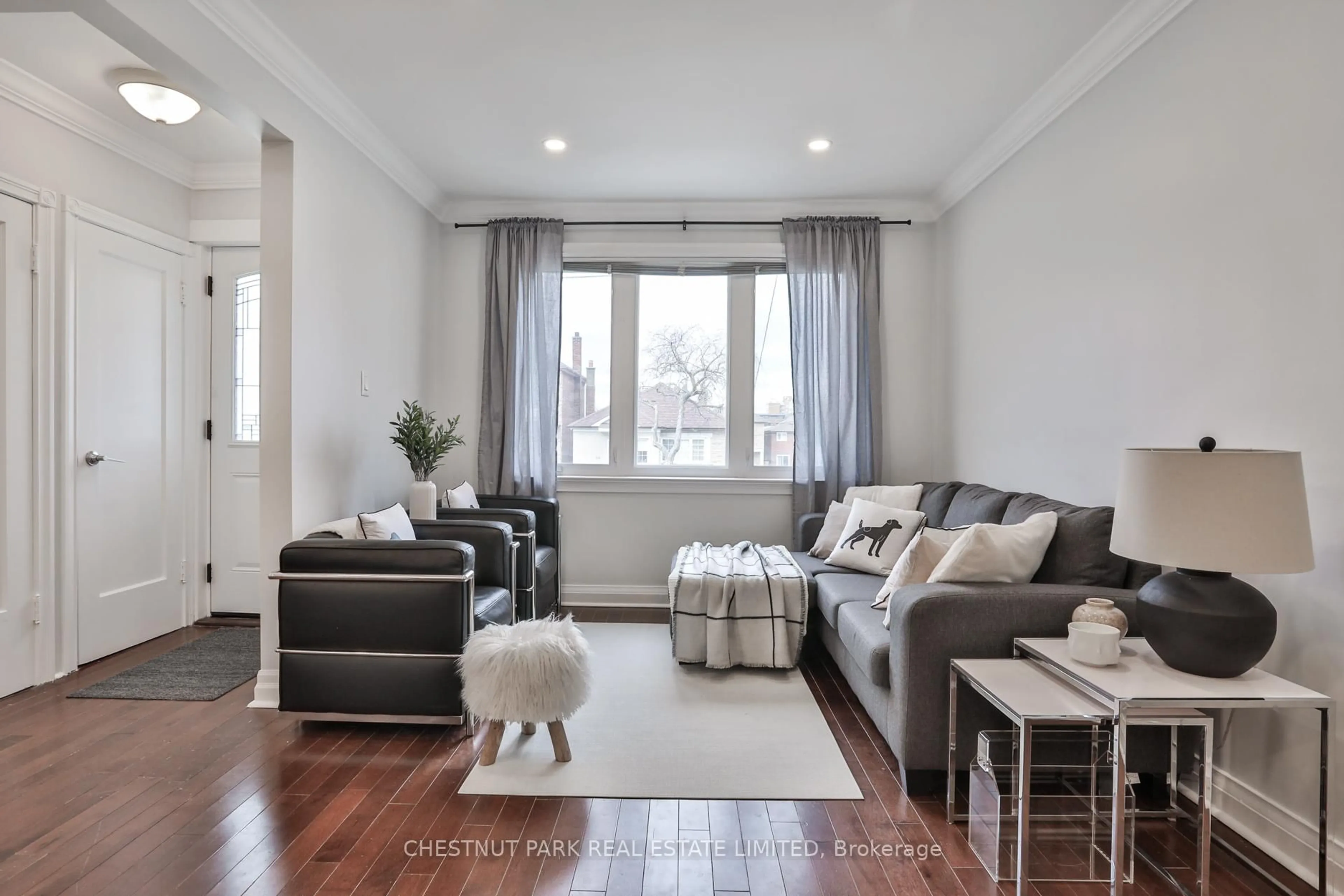 Living room with furniture, wood/laminate floor for 65 Kane Ave, Toronto Ontario M6M 3M8