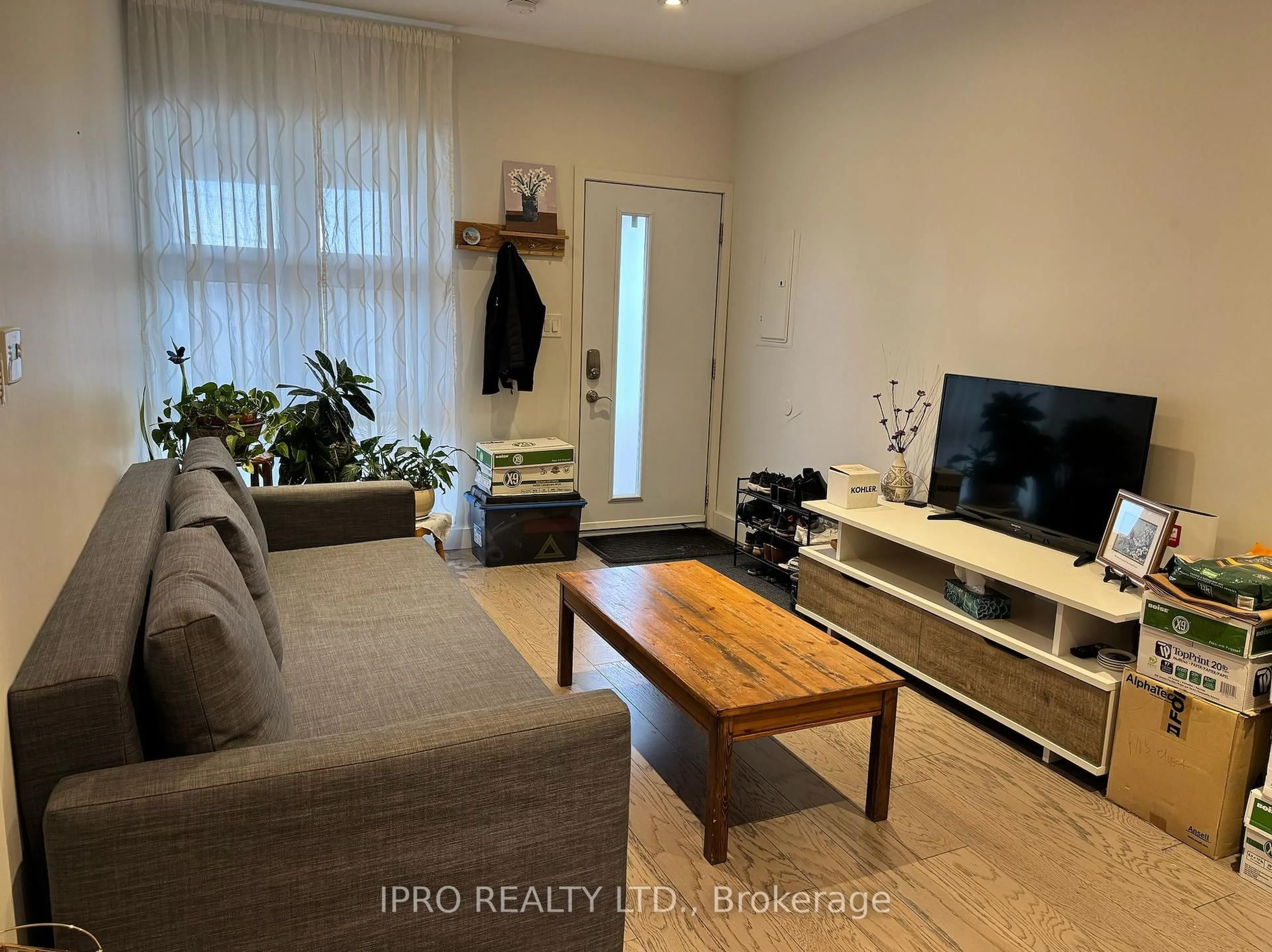 Living room with furniture, wood/laminate floor for 1580 Davenport Rd, Toronto Ontario M6H 2J2