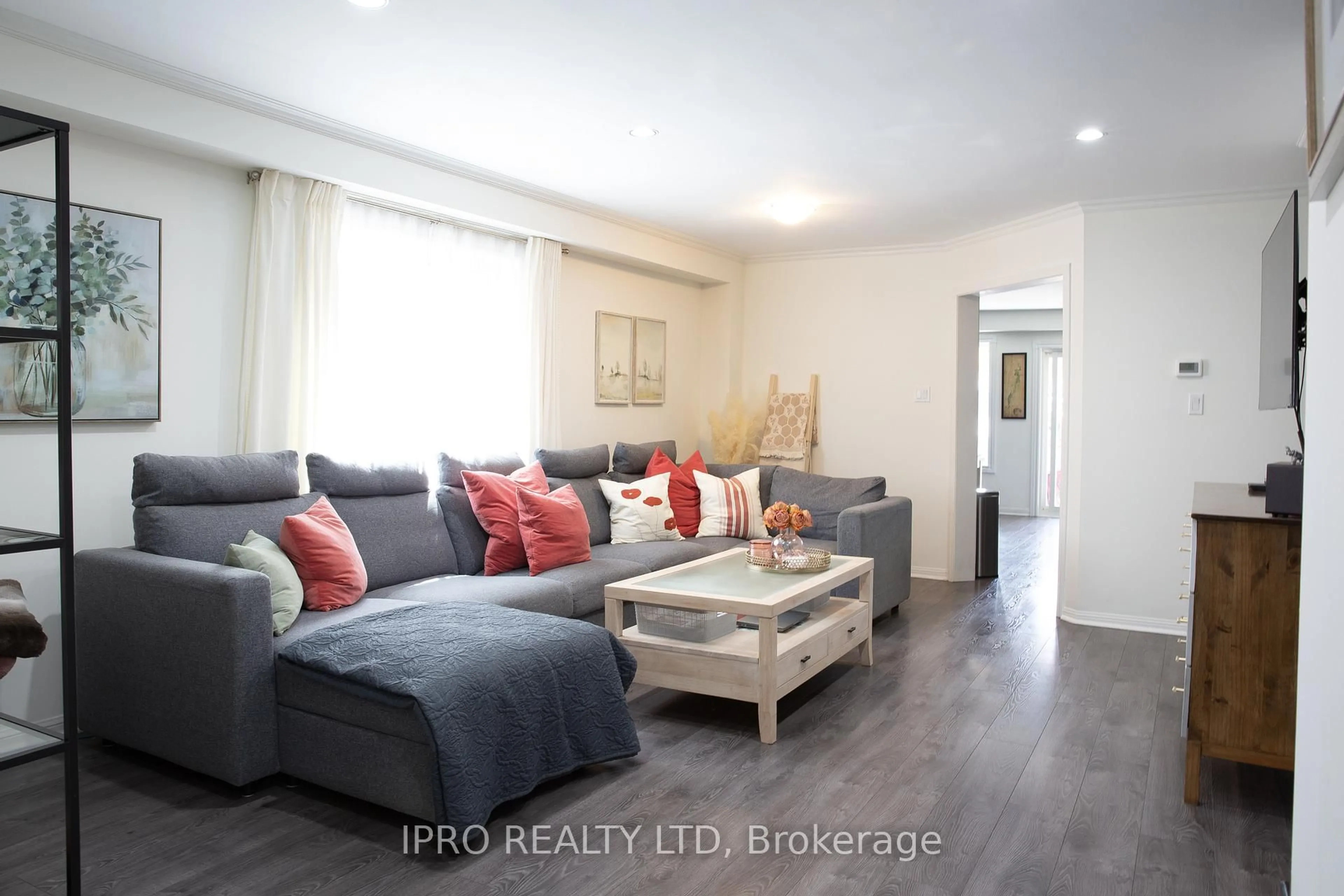 Living room with furniture, wood/laminate floor for 82 Weather Vane Lane, Brampton Ontario L6X 4R4