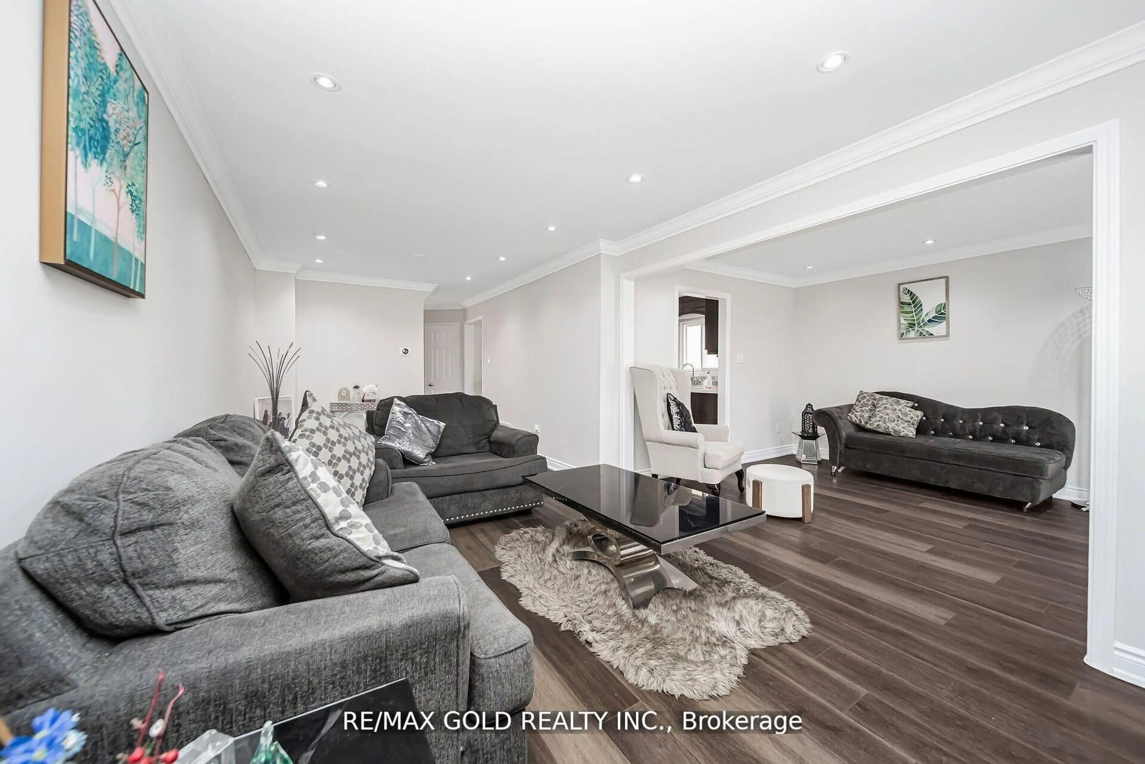 Living room with furniture, wood/laminate floor for 167 Ecclestone Dr, Brampton Ontario L6X 3R1