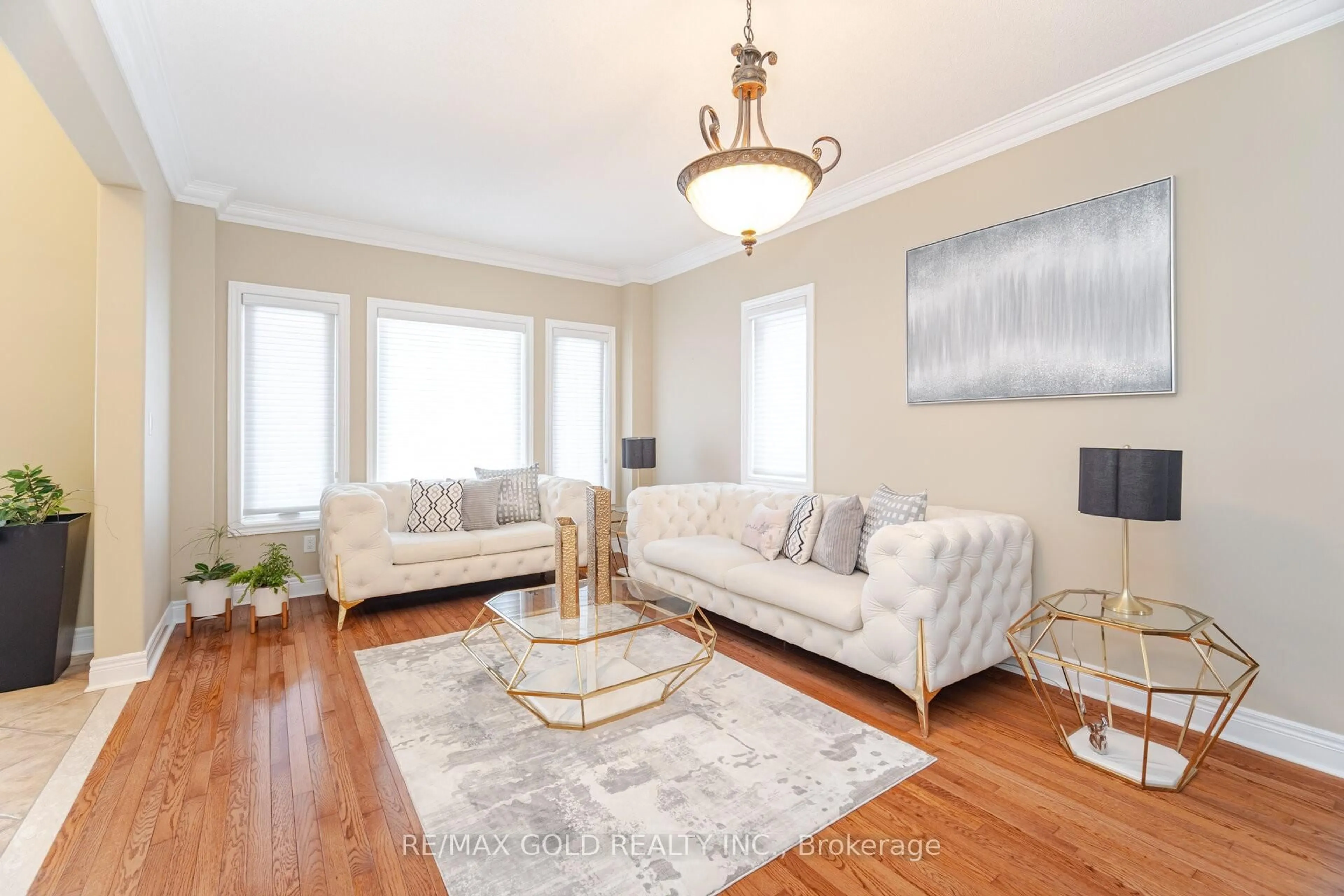 Living room with furniture, wood/laminate floor for 59 Saint Hubert Dr, Brampton Ontario L6P 1Y5
