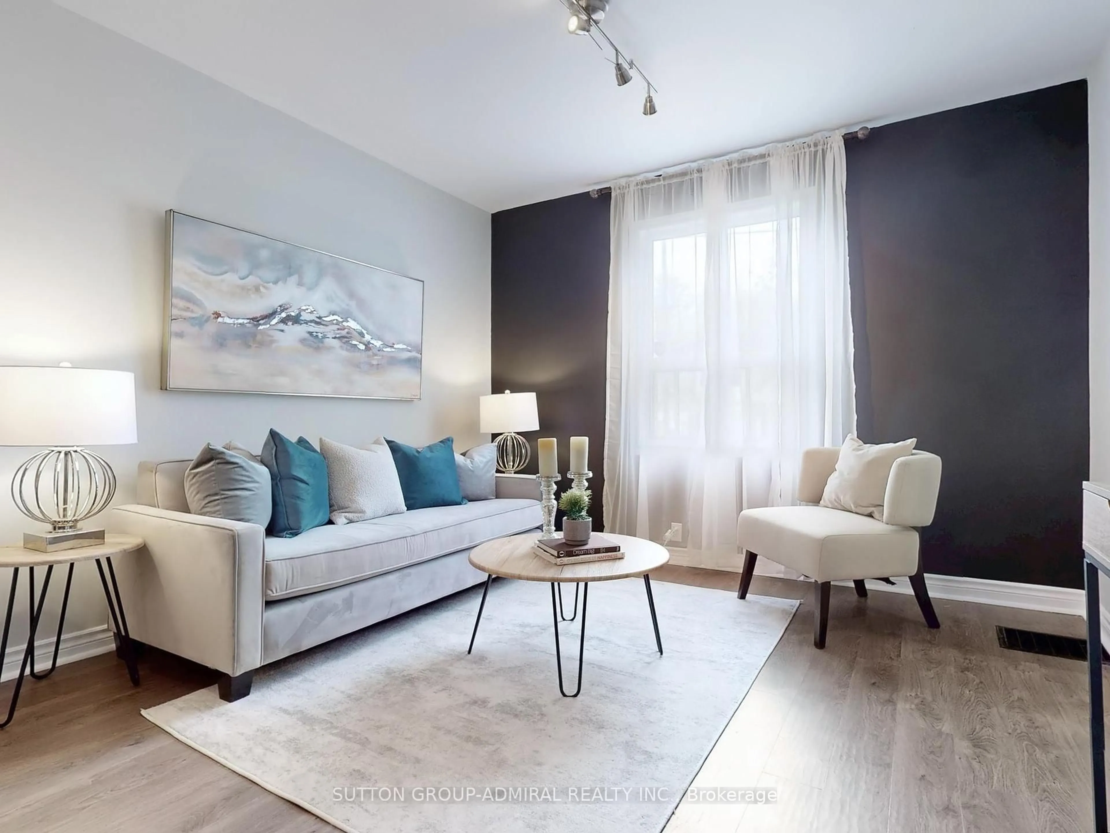 Living room with furniture, wood/laminate floor for 13 Rutherford Ave, Toronto Ontario M6M 2C5