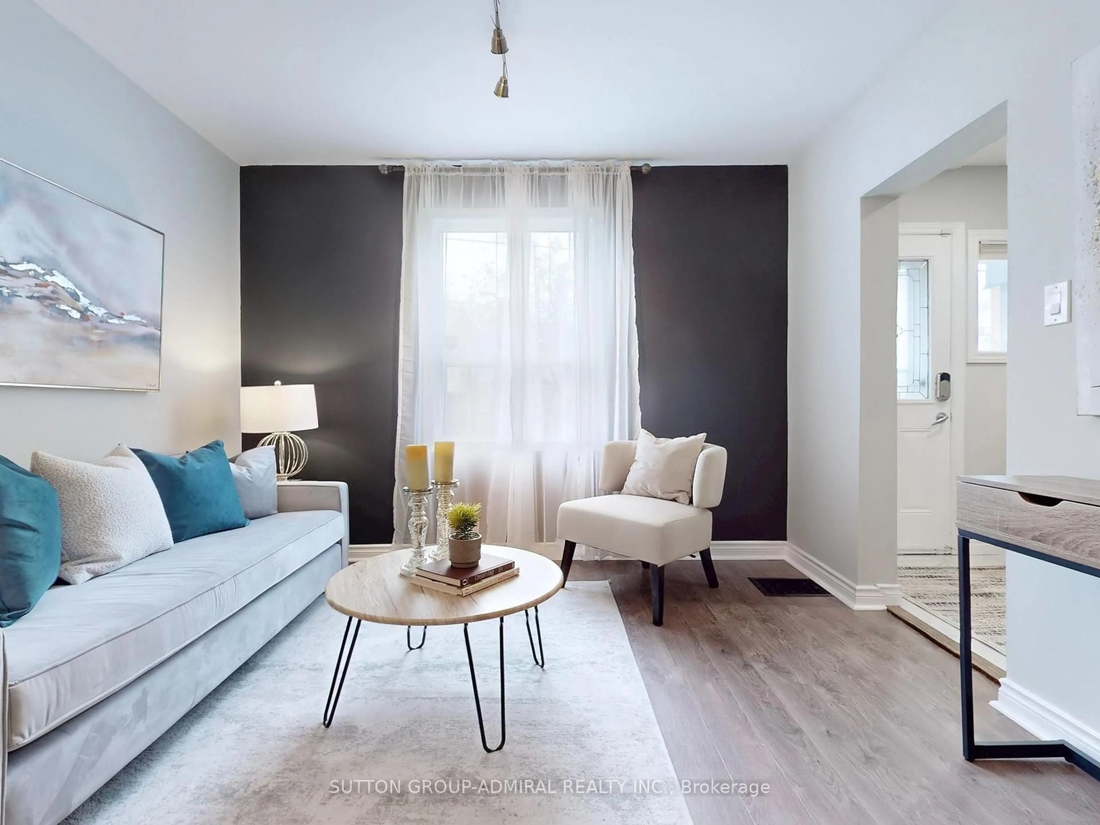 Living room with furniture, wood/laminate floor for 13 Rutherford Ave, Toronto Ontario M6M 2C5