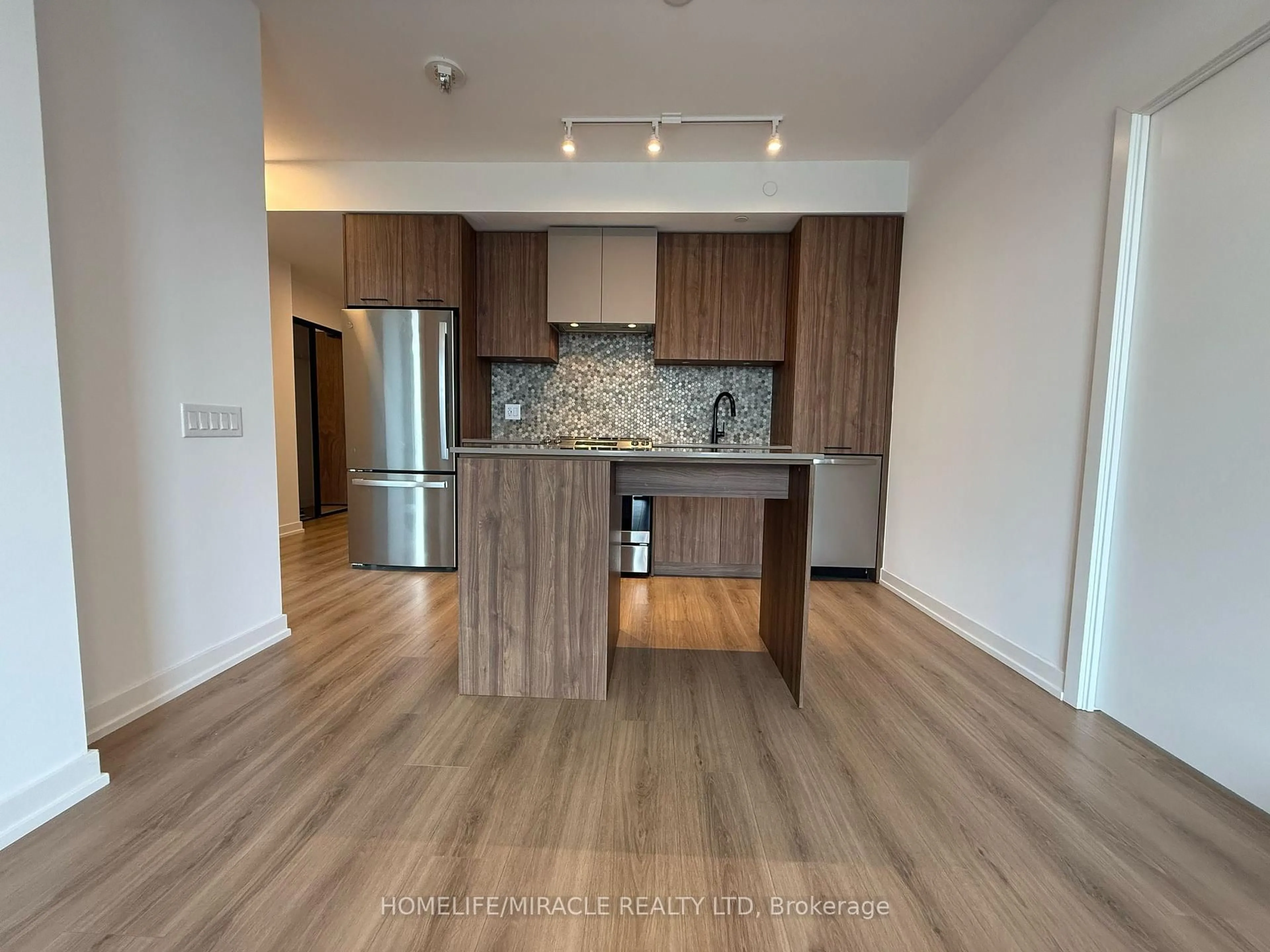Open concept kitchen, wood/laminate floor for 10 Lagerfeld Dr #306, Brampton Ontario L7A 5L3