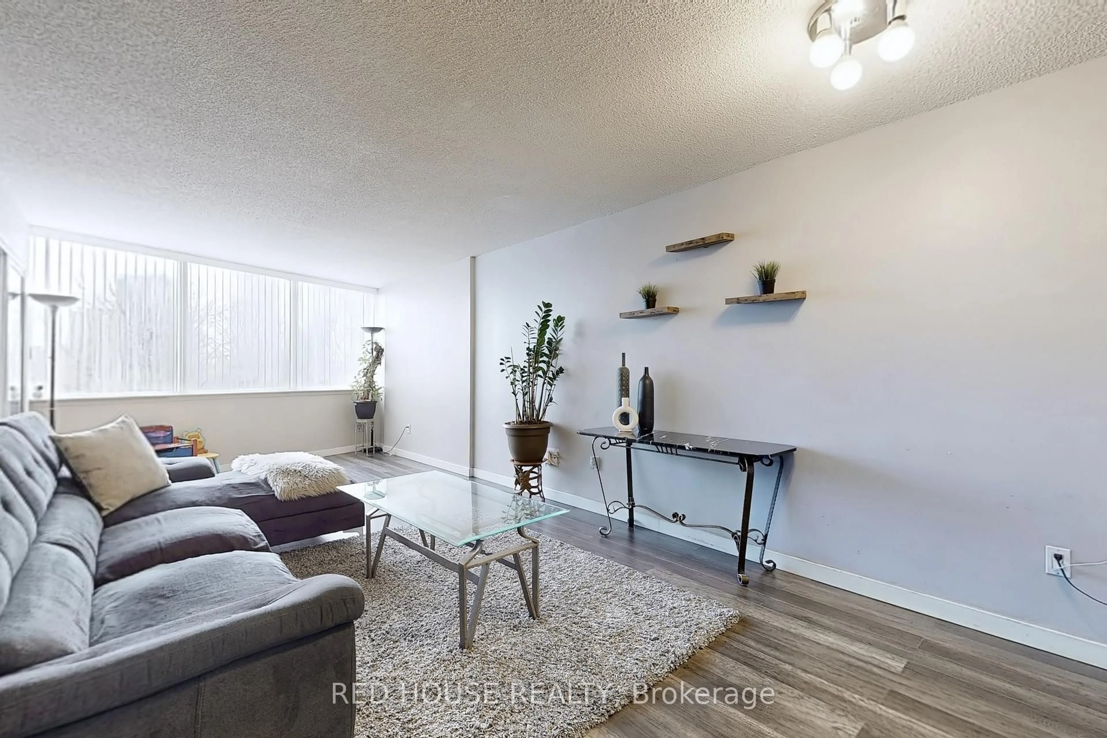 Living room with furniture, wood/laminate floor for 10 Markbrook Lane #206, Toronto Ontario M9V 5E3