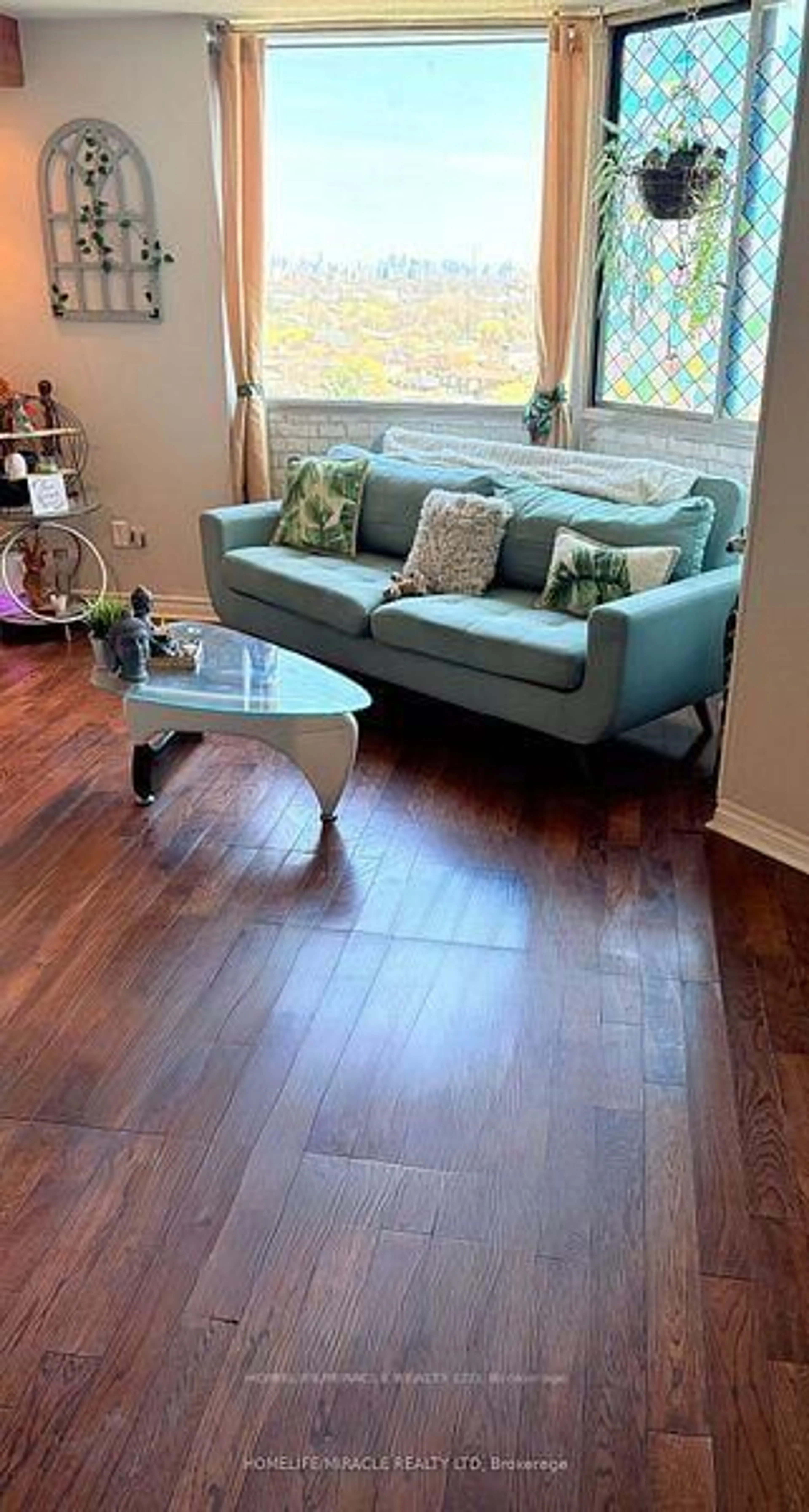 Living room with furniture, wood/laminate floor for 236 Albion Rd #1802, Toronto Ontario M9W 6A6