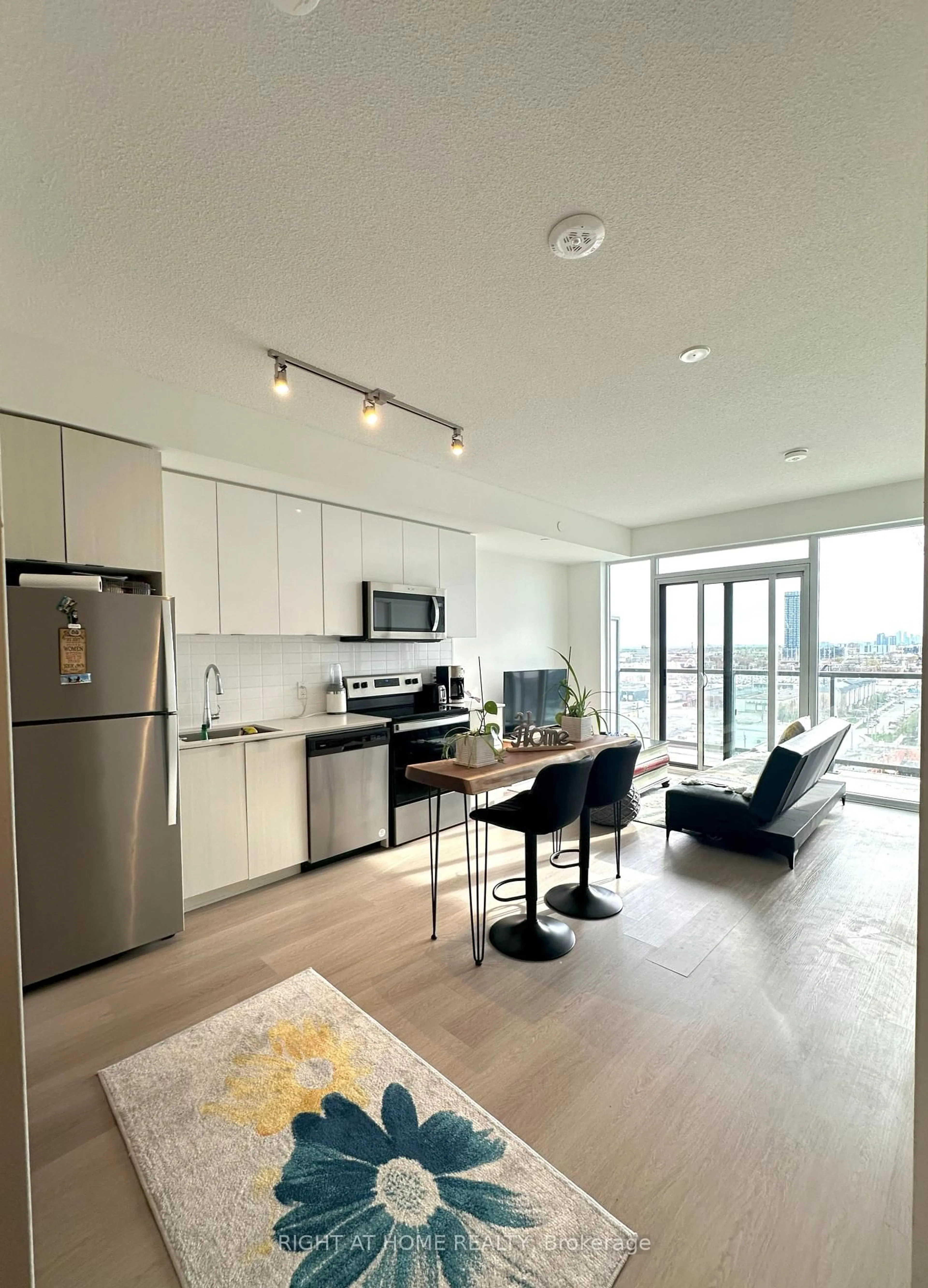 Open concept kitchen, wood/laminate floor for 859 The Queensway St #906, Toronto Ontario M8Z 1N8
