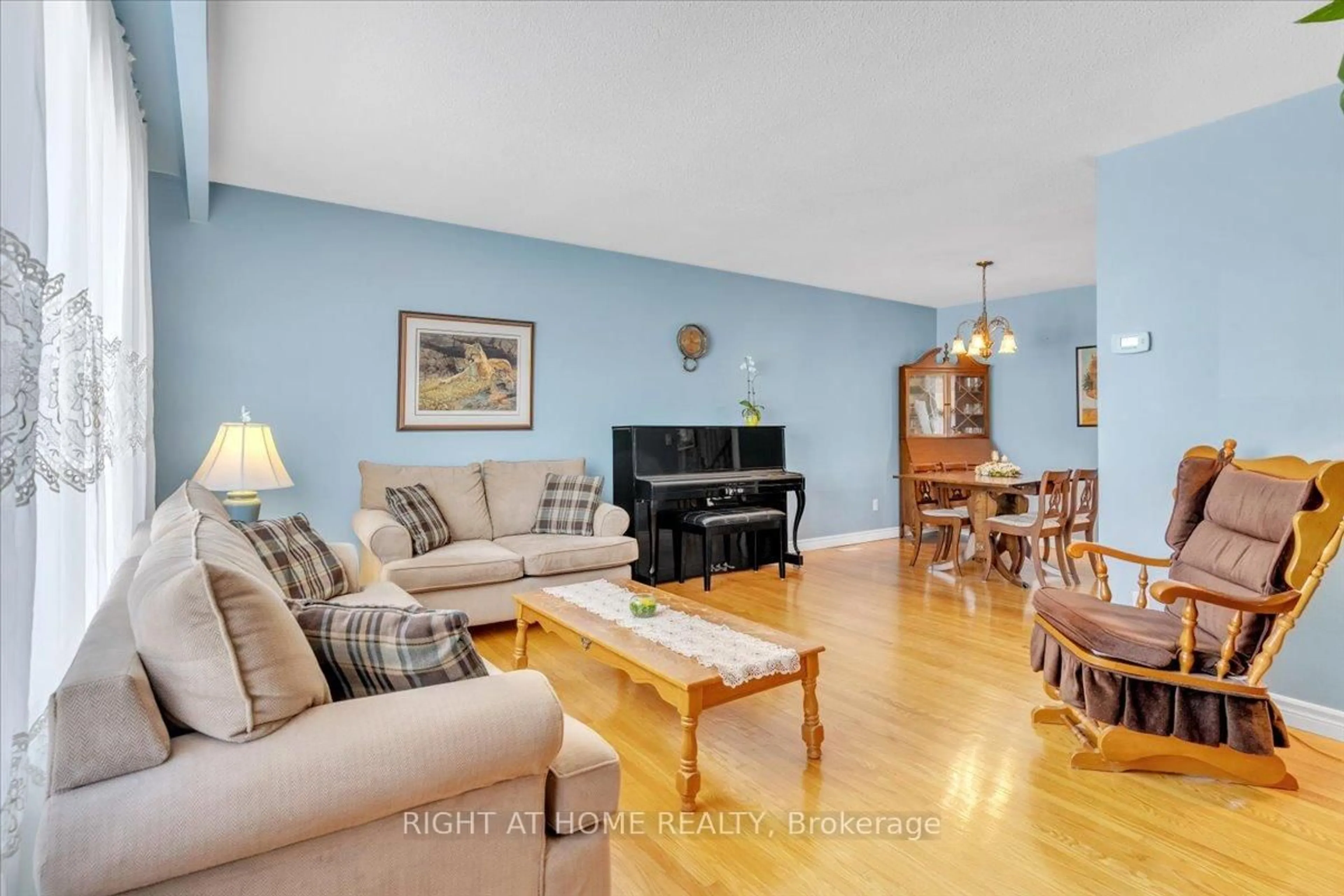 Living room with furniture, wood/laminate floor for 21 Willis Dr, Brampton Ontario L6W 1A8
