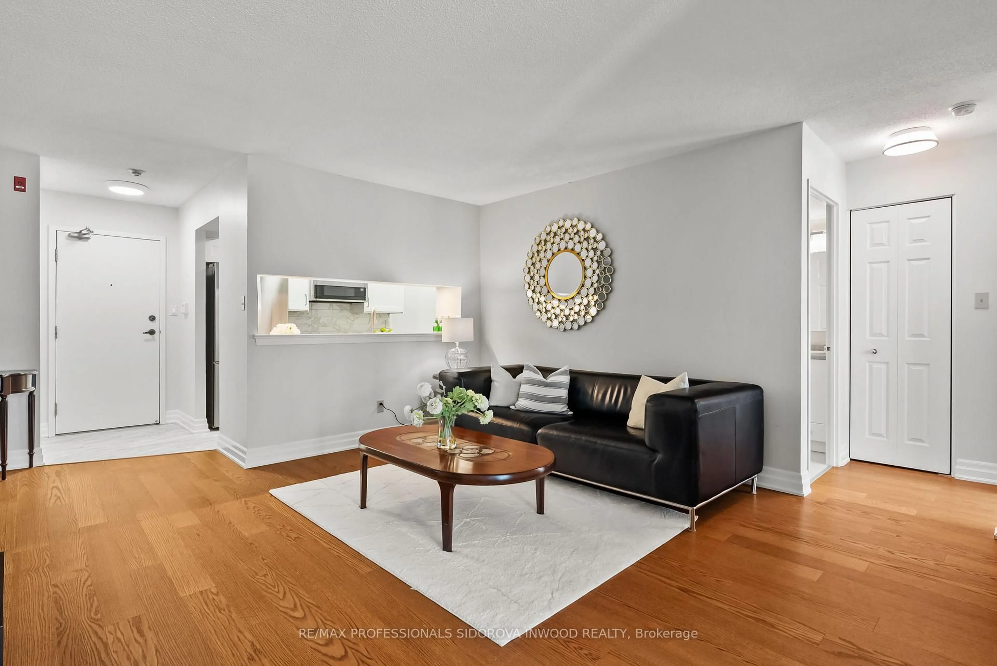 Living room with furniture, wood/laminate floor for 20 Southport St #321, Toronto Ontario M6S 4Y8