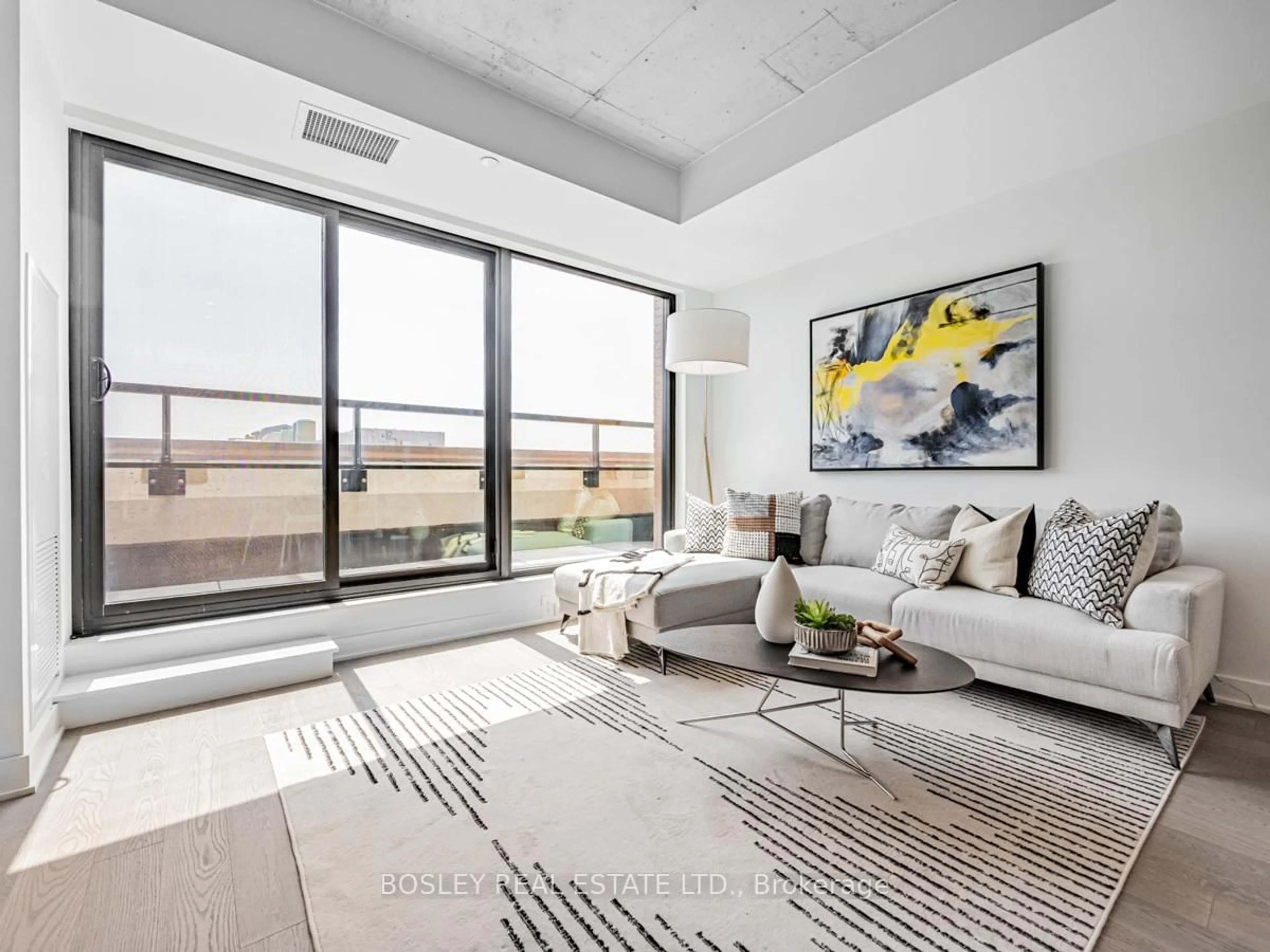 Living room with furniture, cement floor for 2720 Dundas St #406, Toronto Ontario M6P 1Y2