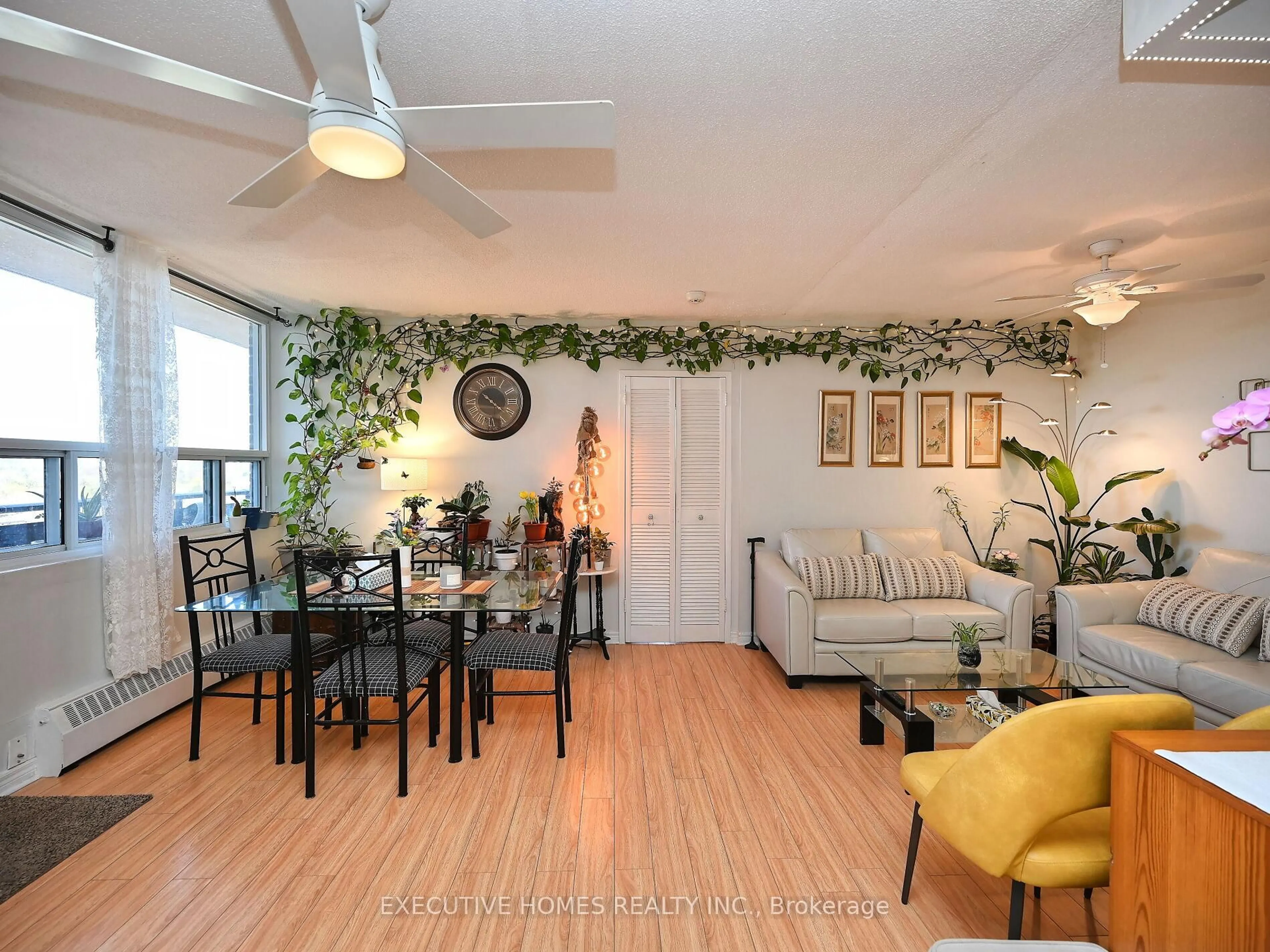 Living room with furniture, wood/laminate floor for 3065 Queen Frederica Dr #1107, Mississauga Ontario L4Y 3A3
