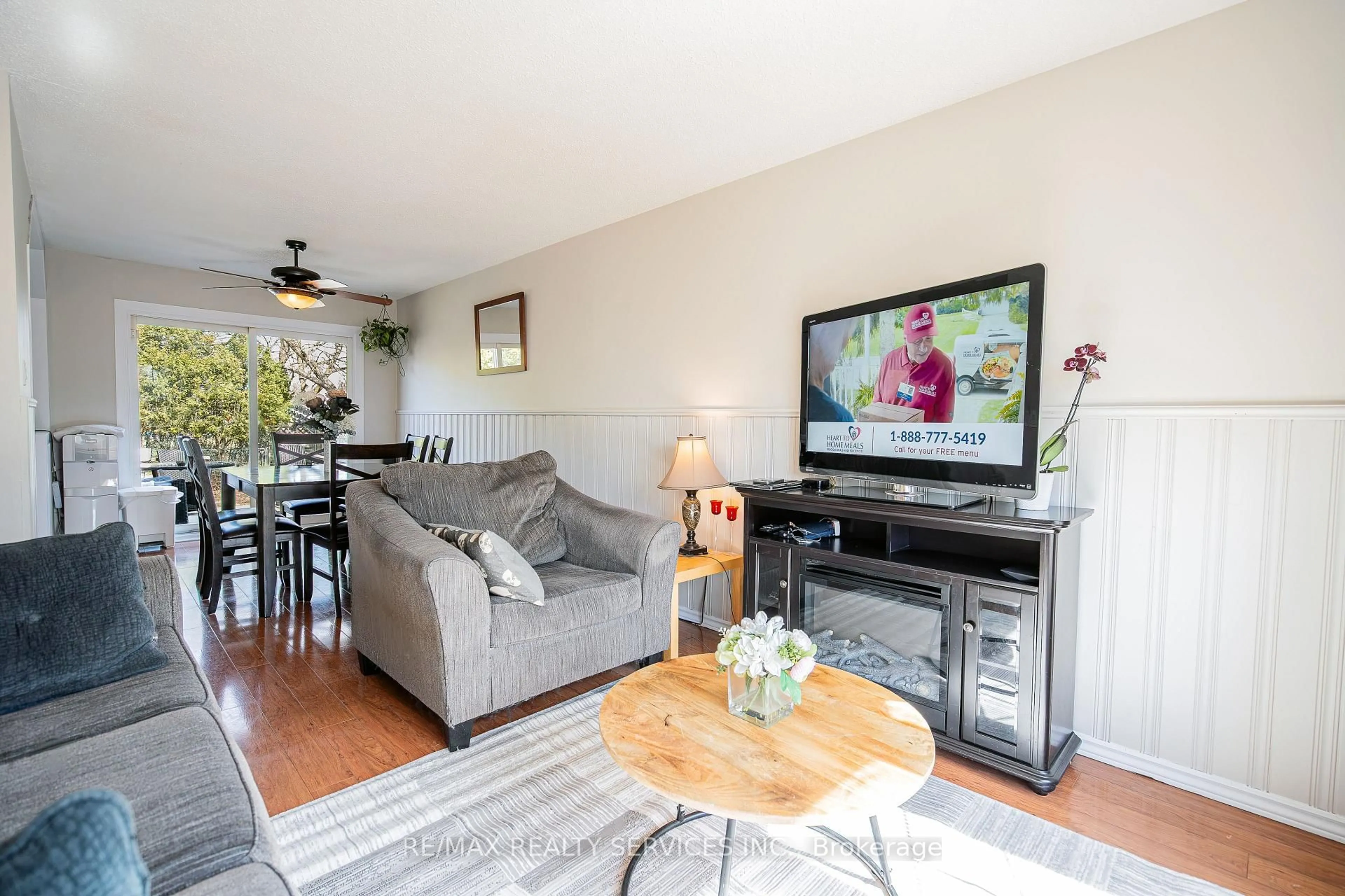 Living room with furniture, wood/laminate floor for 96 Seaborn Rd, Brampton Ontario L6V 2C1