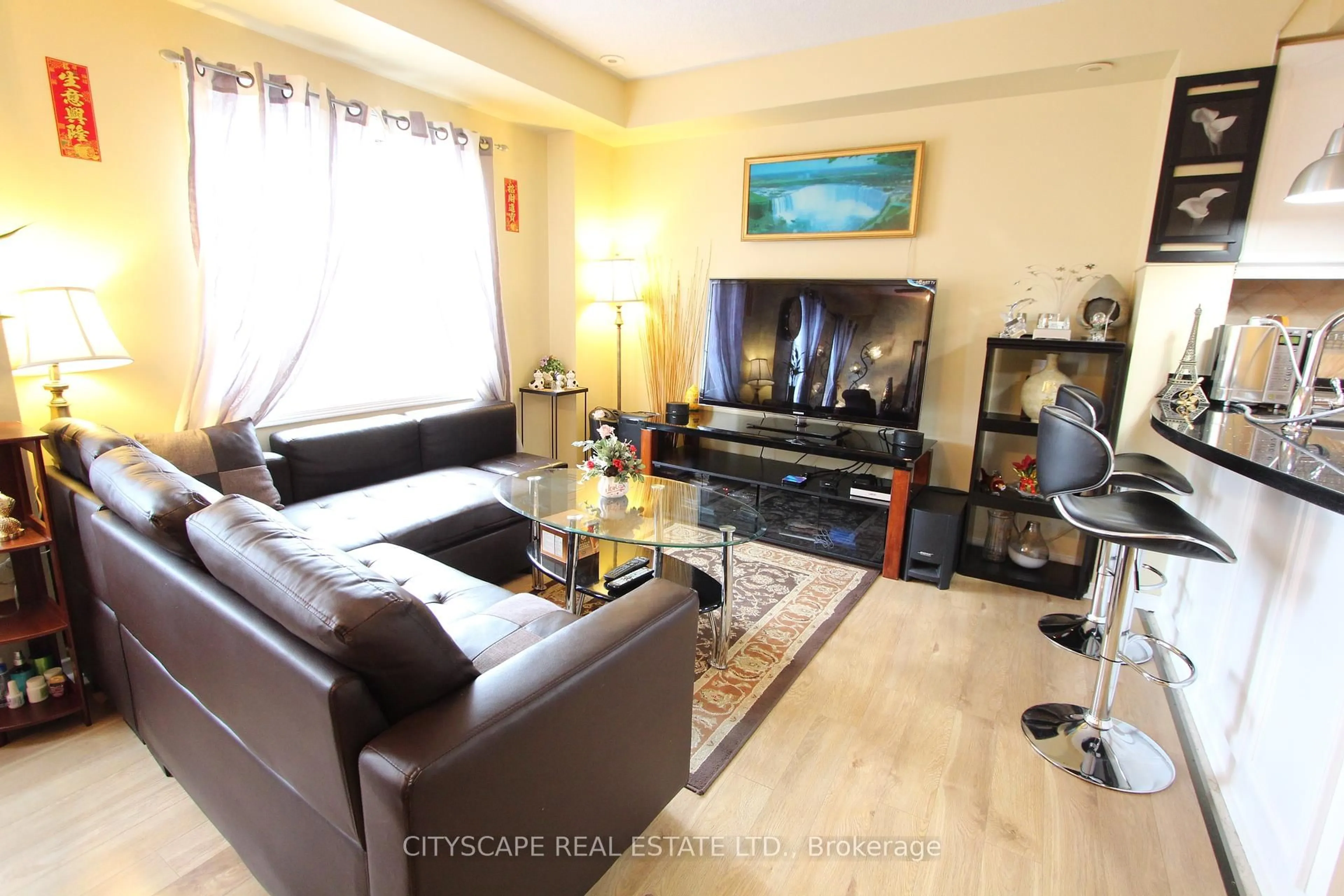 Living room with furniture, wood/laminate floor for 3055 Elmcreek Rd #7, Mississauga Ontario L5B 4J9