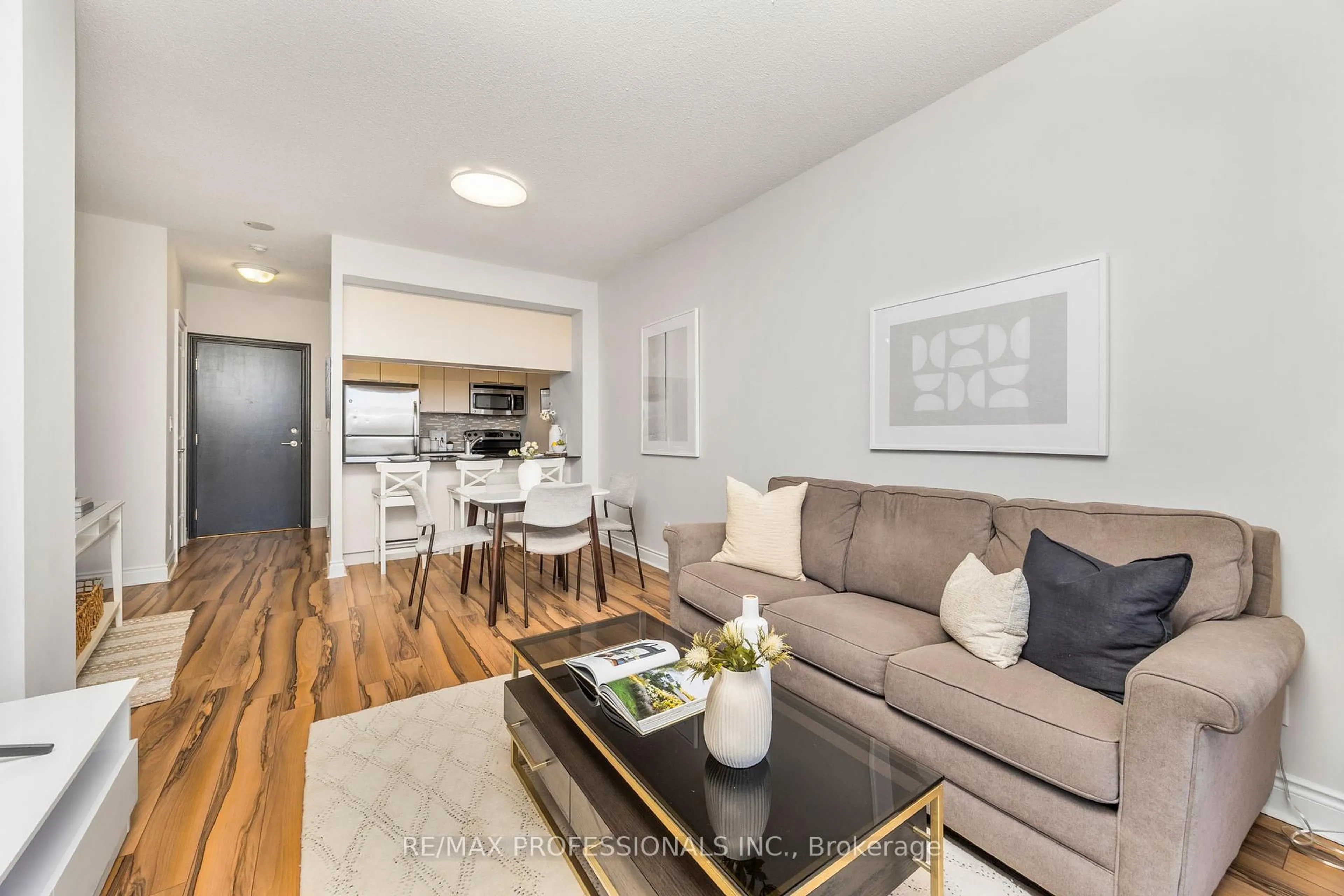 Living room with furniture, wood/laminate floor for 16 Brookers Lane #302, Toronto Ontario M8V 0A5