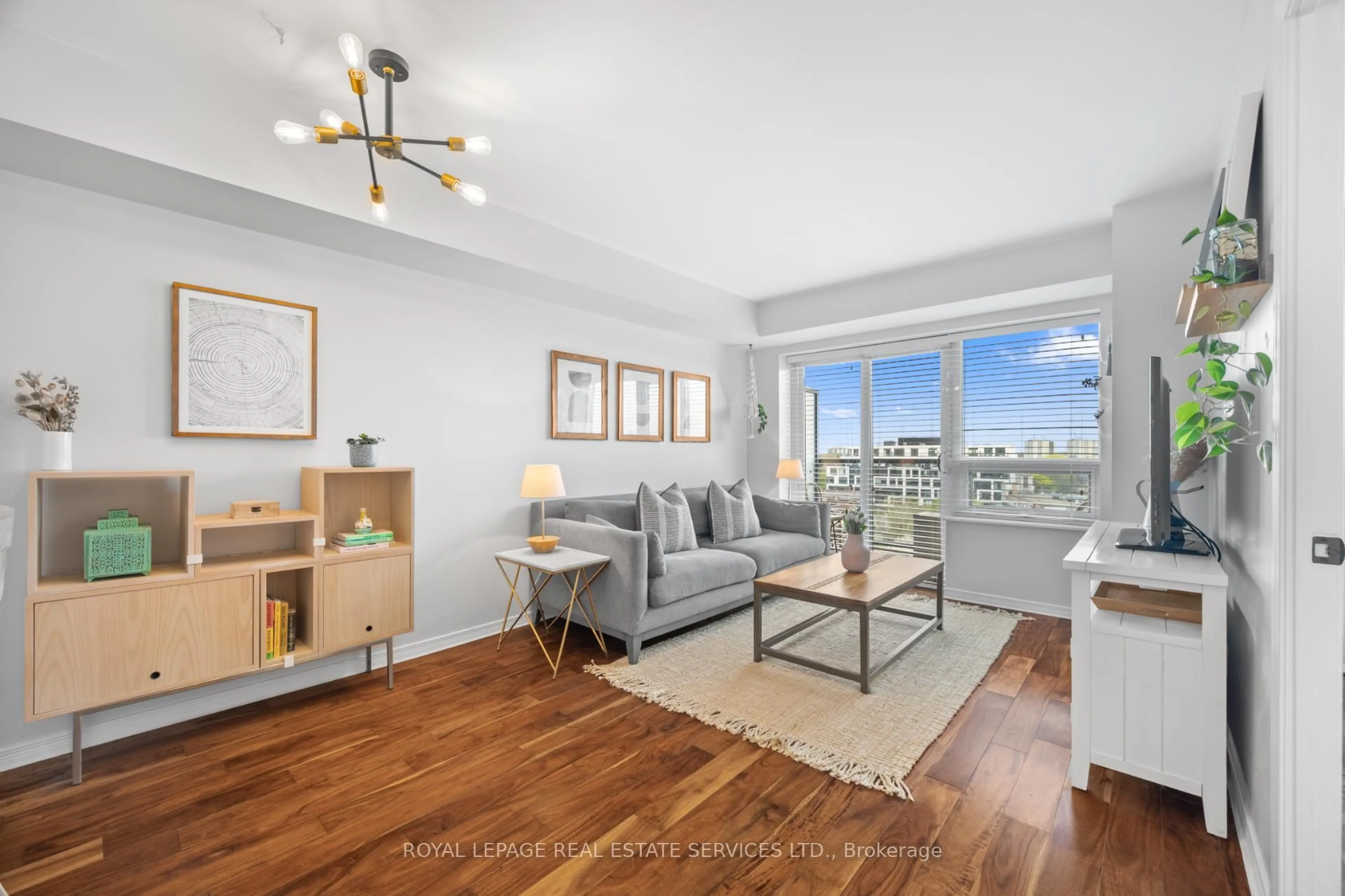 Living room with furniture, wood/laminate floor for 61 Heintzman St #812, Toronto Ontario M6P 5A2