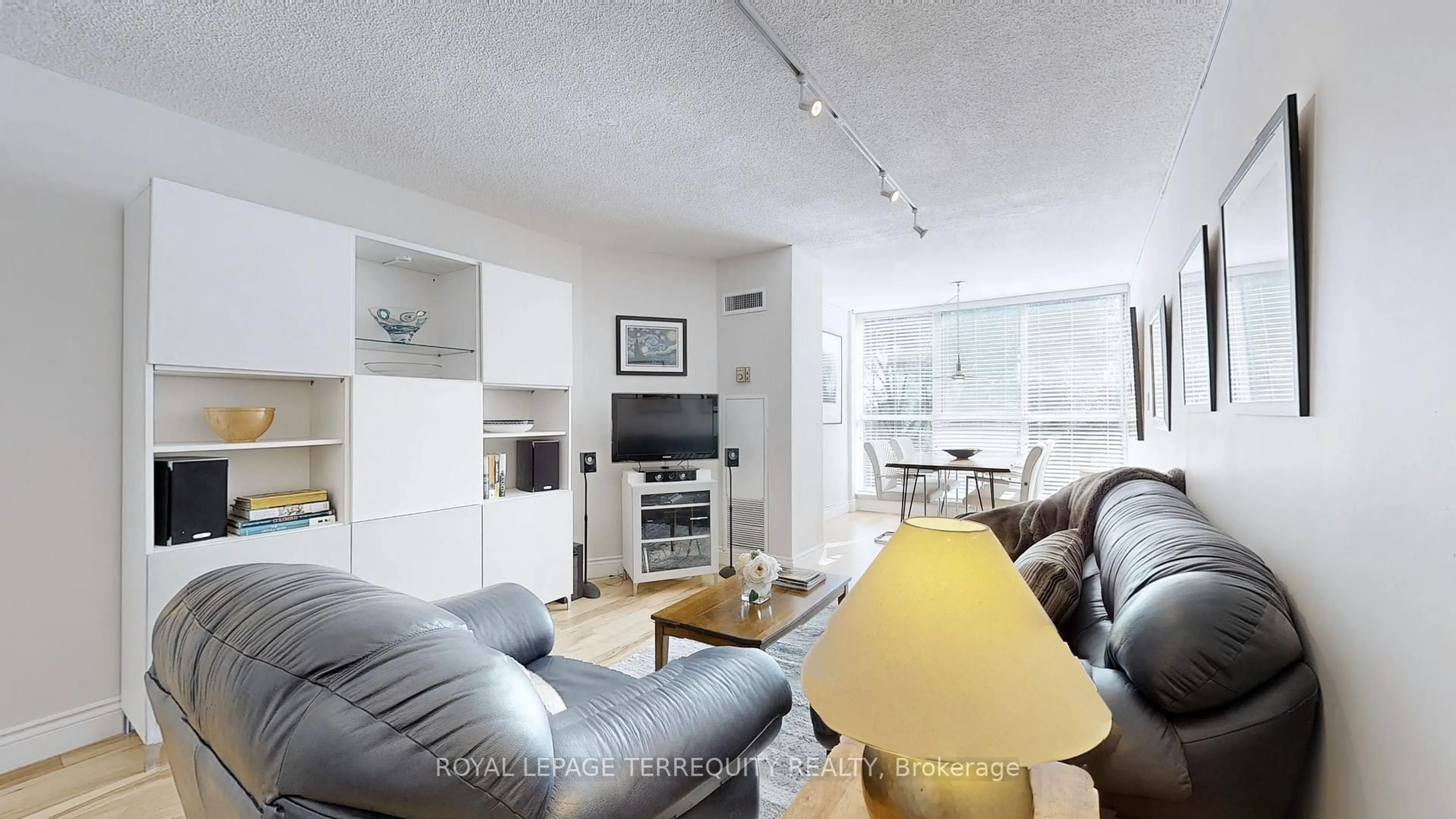 Living room with furniture, wood/laminate floor for 20 Southport St #511, Toronto Ontario M6S 4Y8