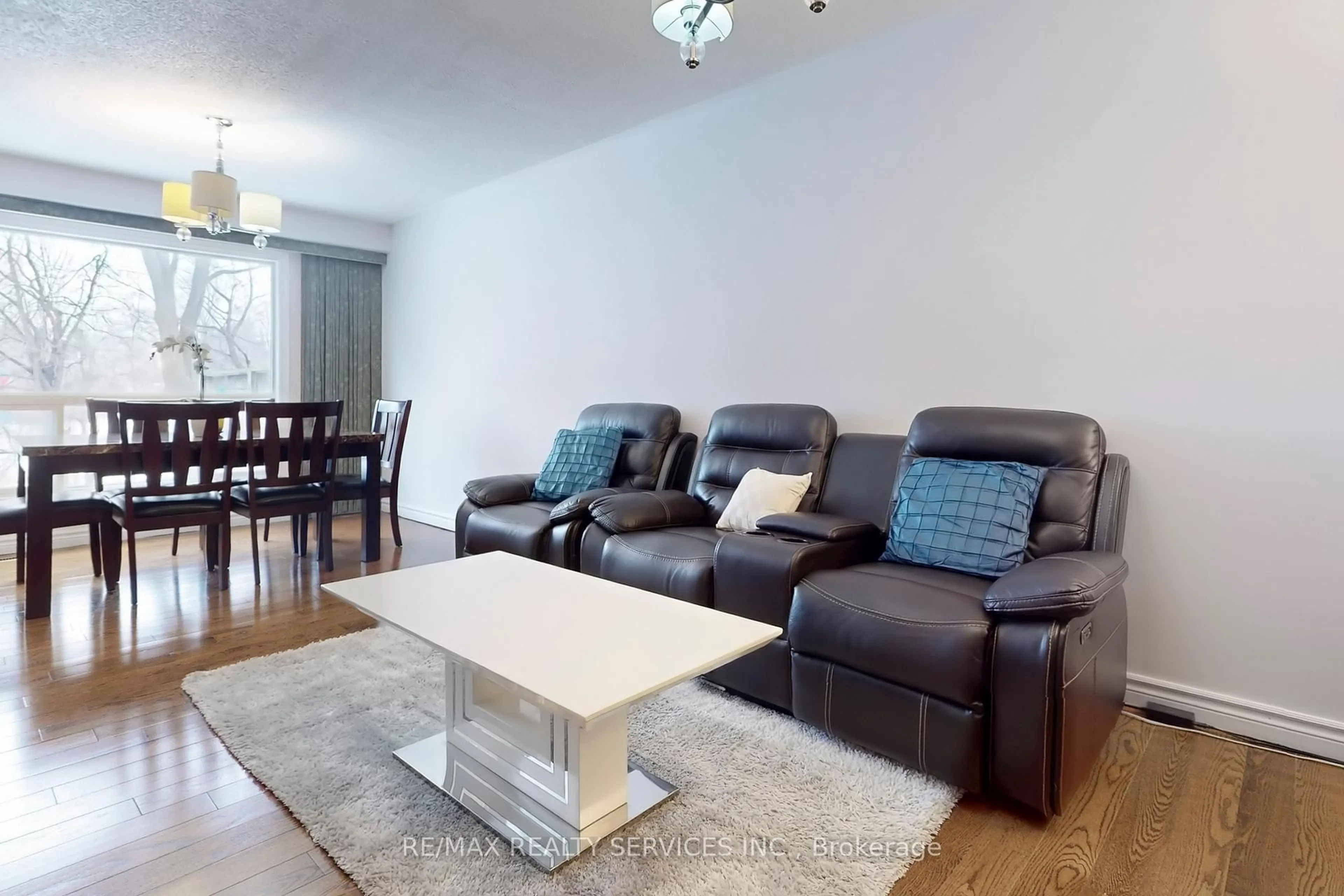 Living room with furniture, wood/laminate floor for 28 Heathcliffe Sq, Brampton Ontario L6S 5P7