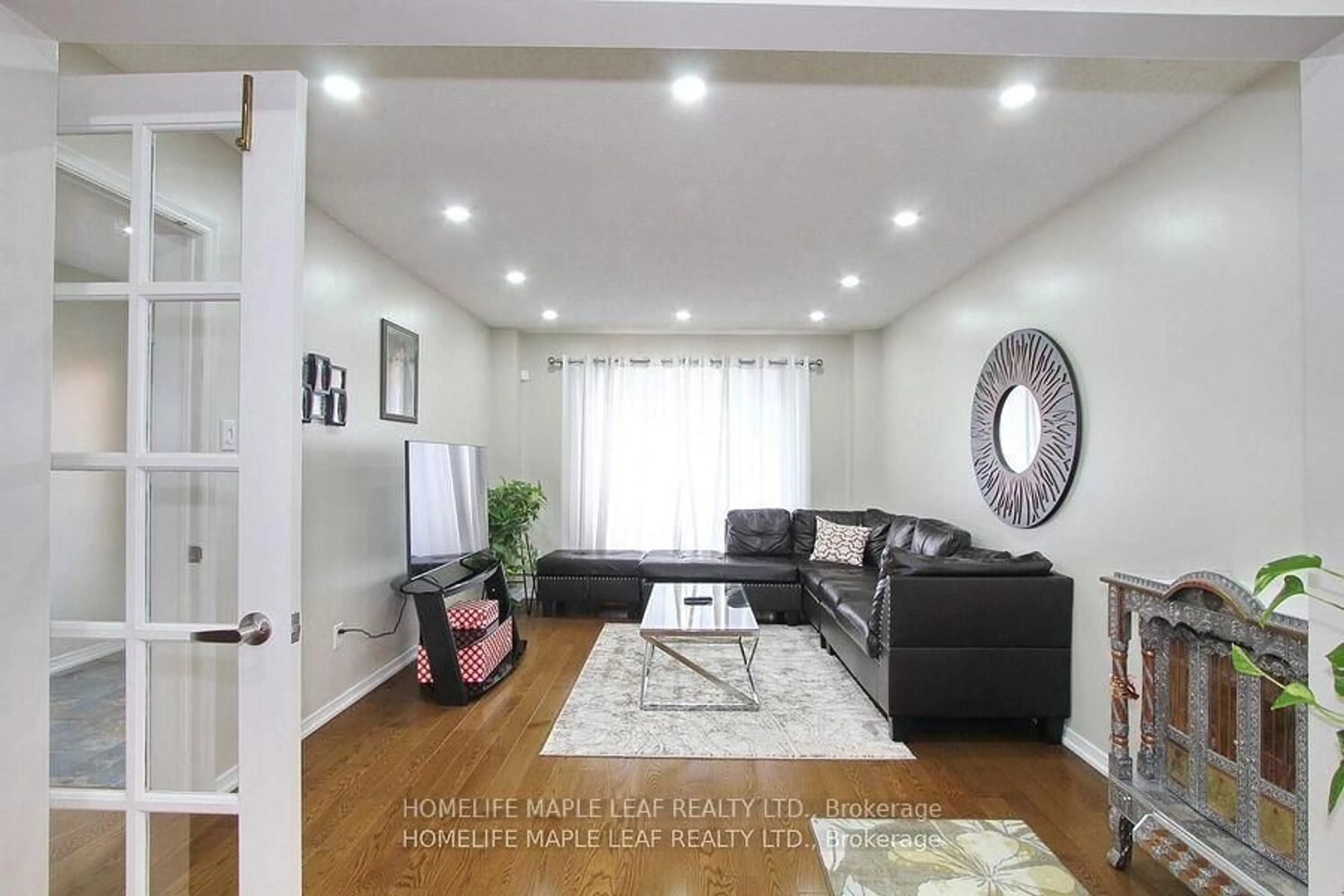 Living room with furniture, wood/laminate floor for 110 Corkett Dr, Brampton Ontario L6X 3E6