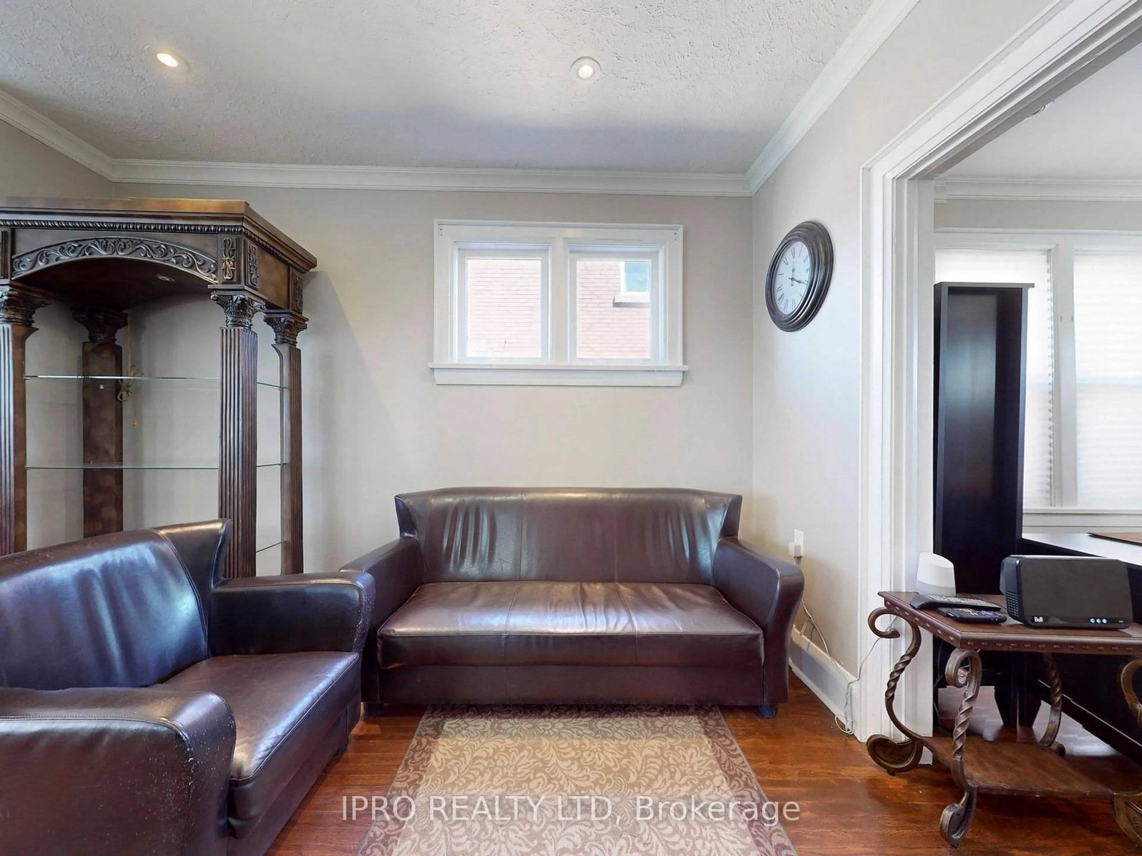 Living room with furniture, wood/laminate floor for 219 Queen St, Brampton Ontario L6Y 1M6