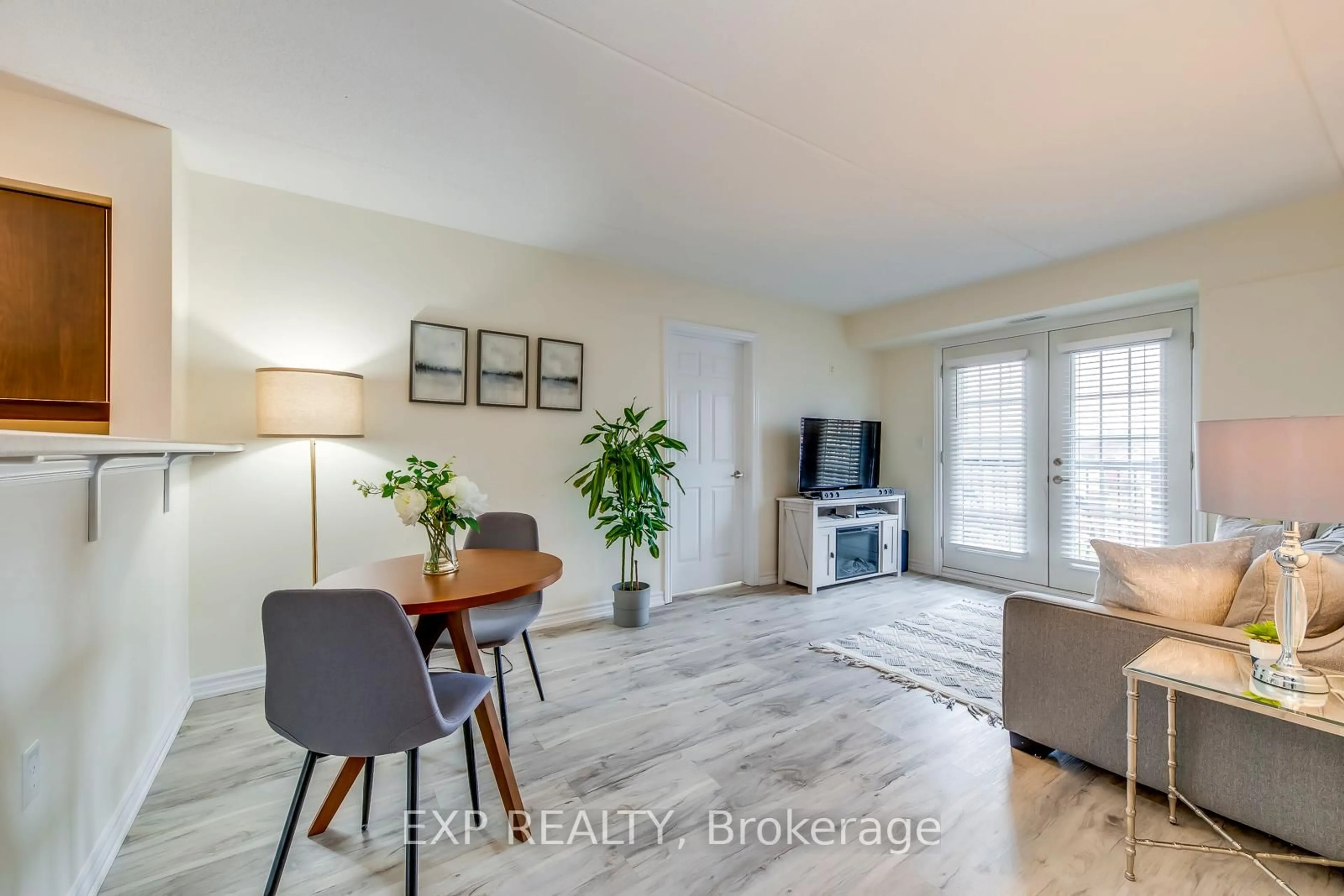 Living room with furniture, wood/laminate floor for 1380 Main St #309, Milton Ontario L9T 7S4