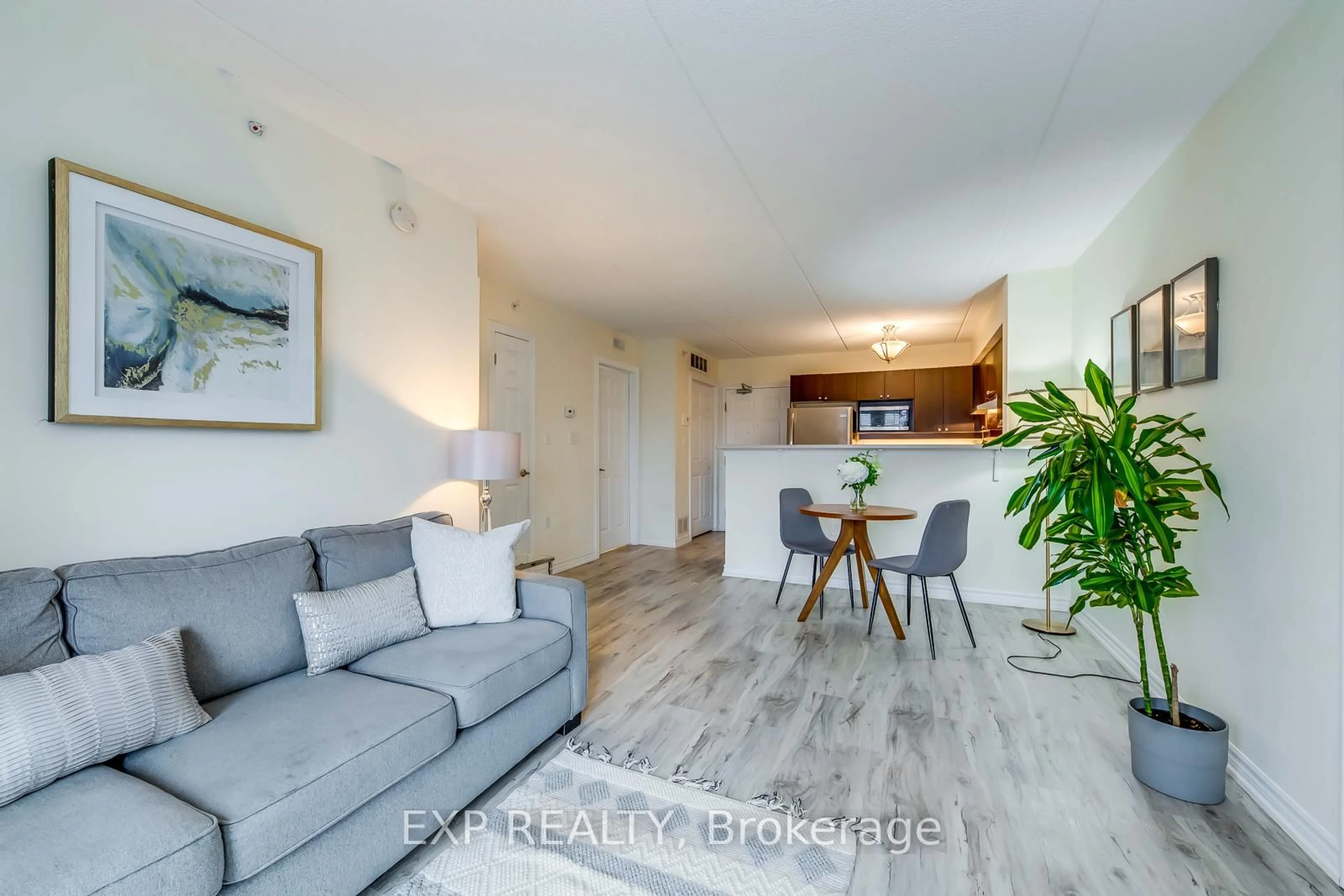 Living room with furniture, wood/laminate floor for 1380 Main St #309, Milton Ontario L9T 7S4