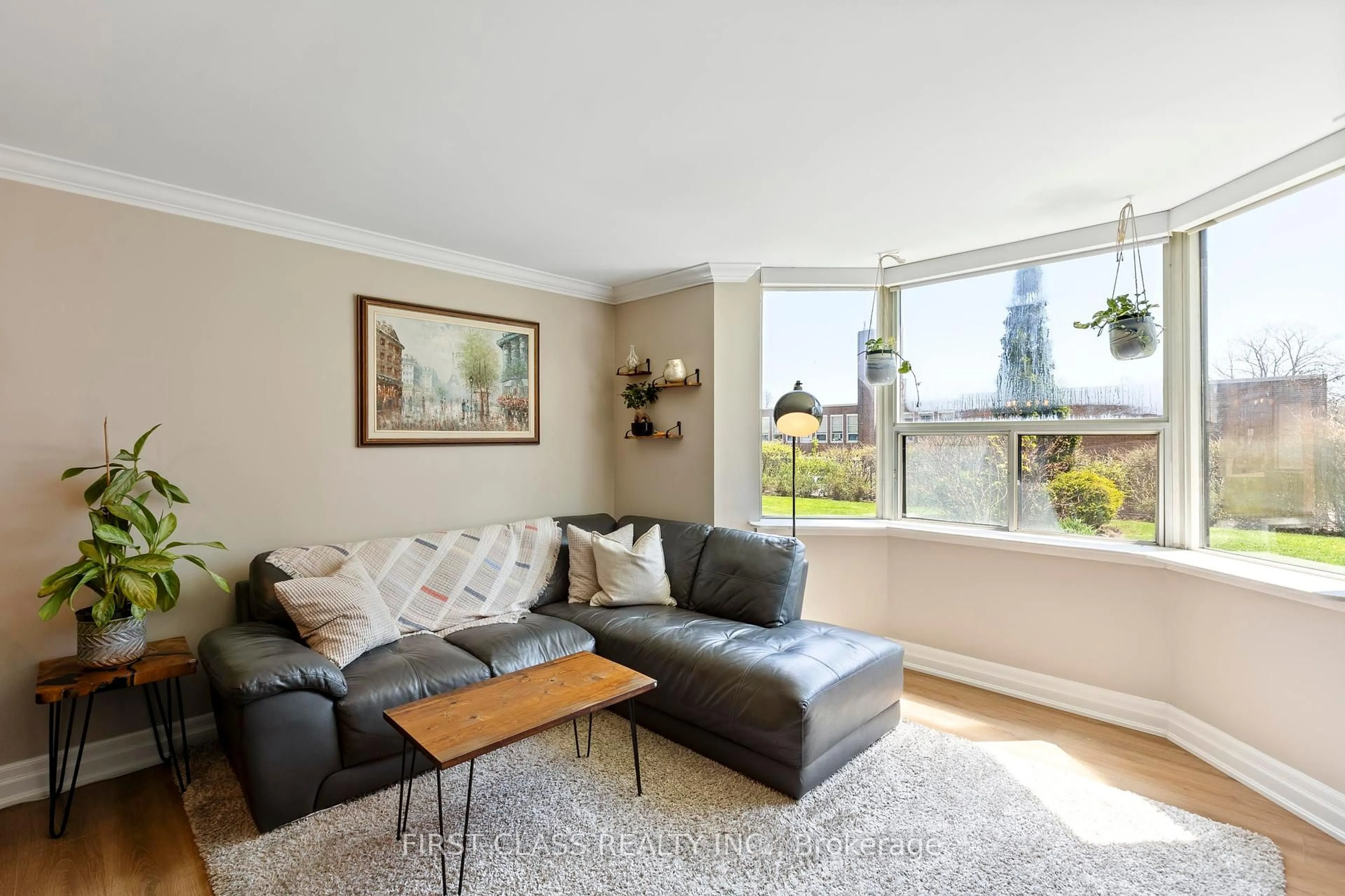 Living room with furniture, wood/laminate floor for 3845 Lake Shore Blvd #102, Toronto Ontario M8W 4Y3