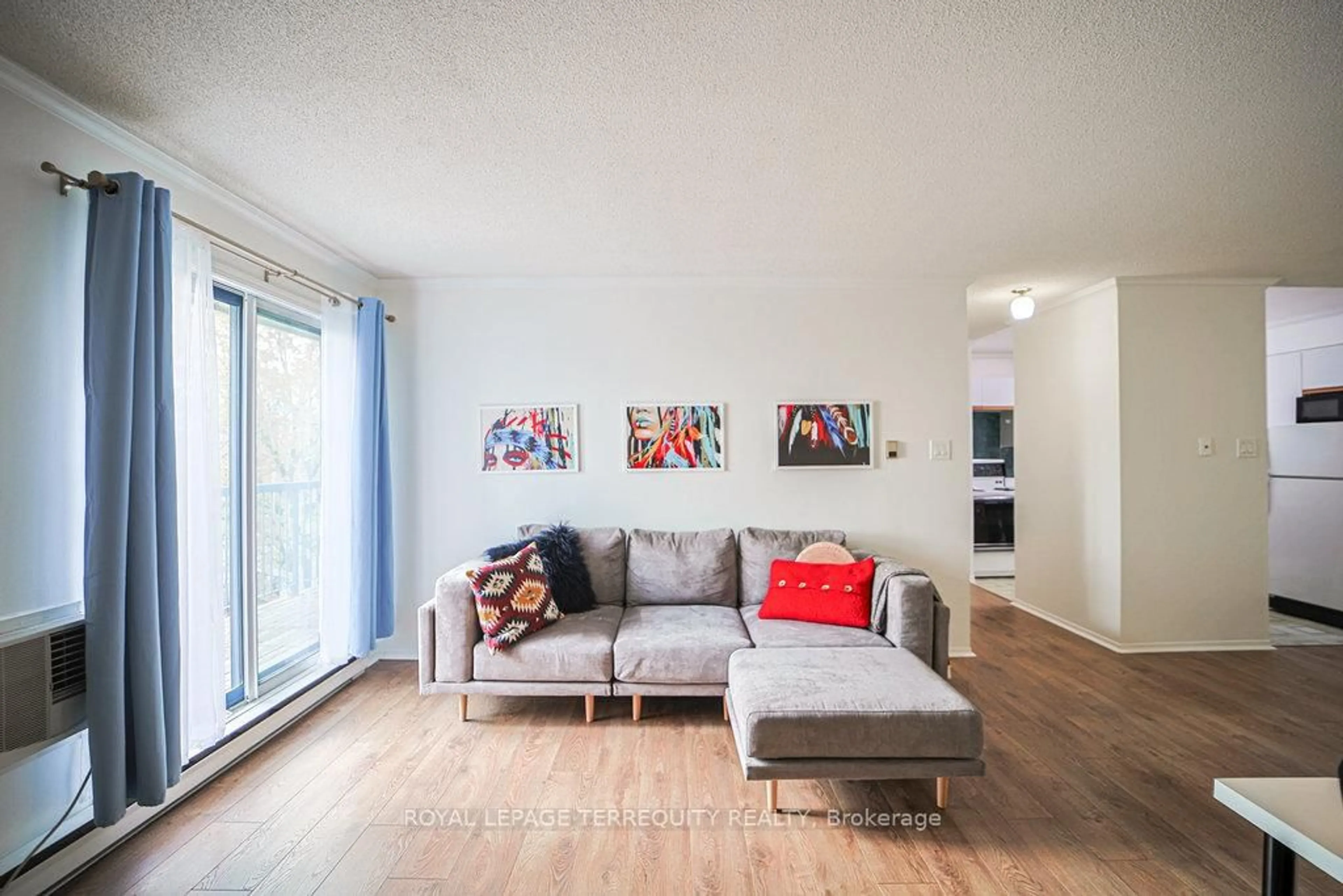 Living room with furniture, wood/laminate floor for 95 Trailwood Dr #832, Mississauga Ontario L4Z 3L2