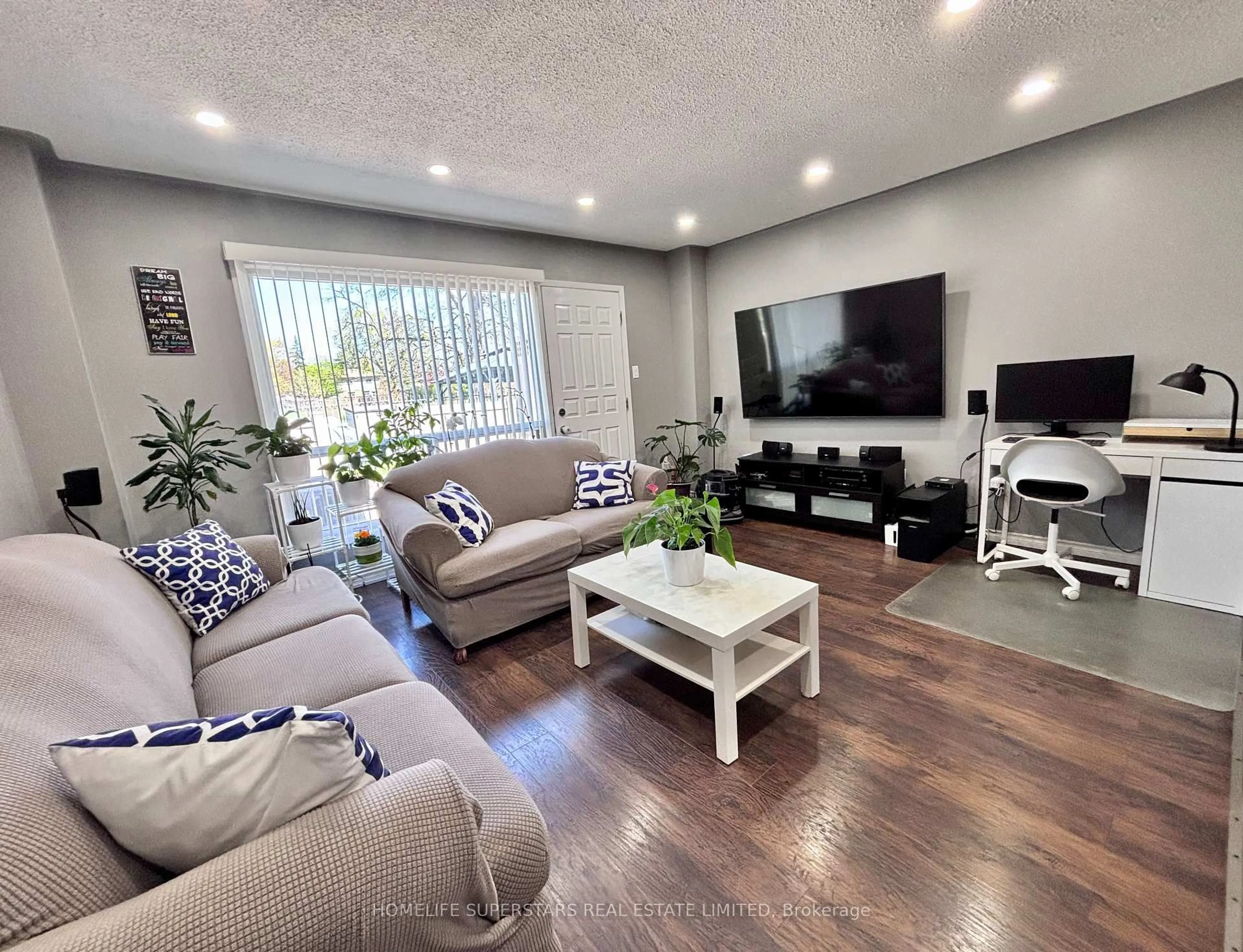 Living room with furniture, wood/laminate floor for 475 Bramalea Rd #65, Brampton Ontario L6T 2X2