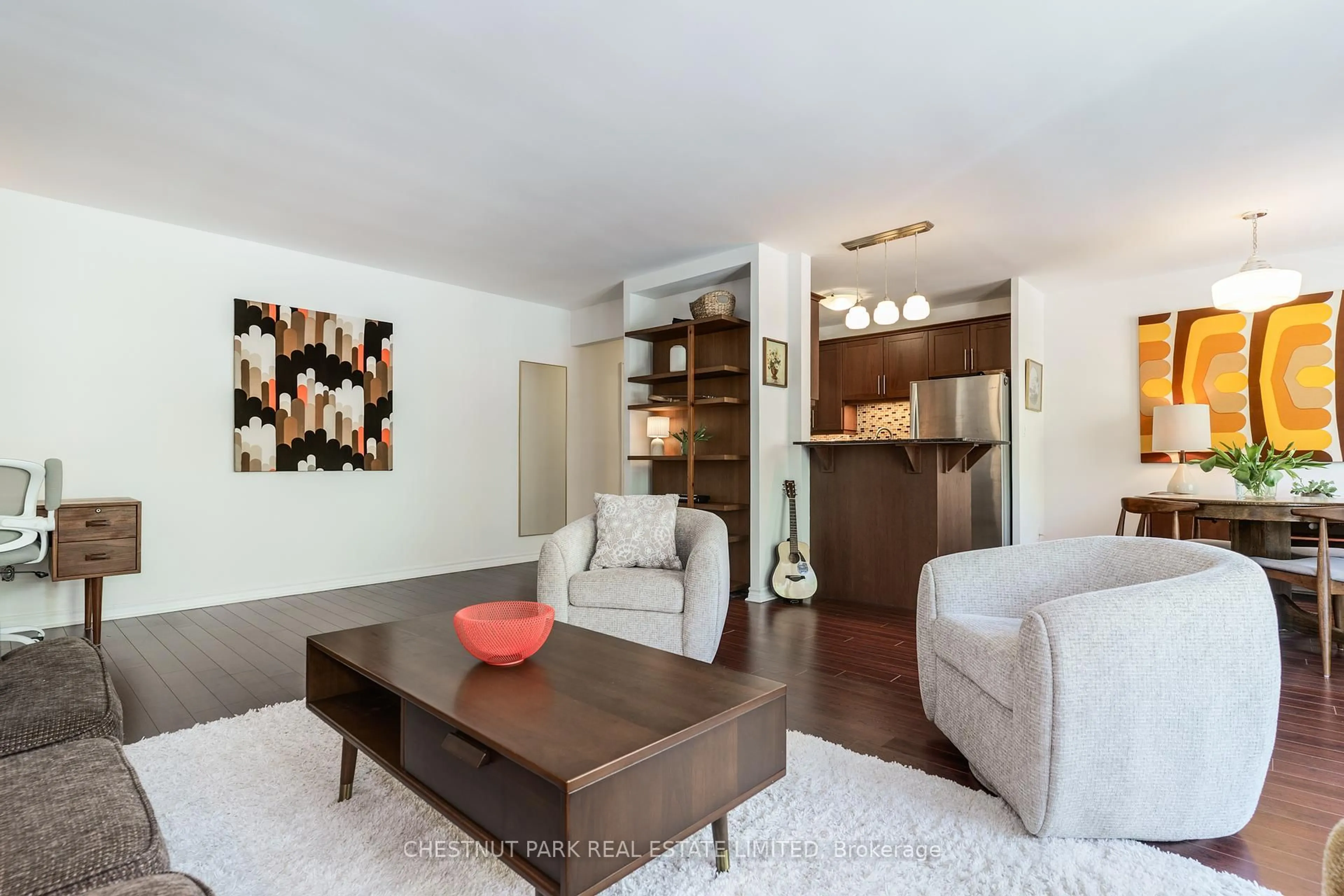 Living room with furniture, wood/laminate floor for 60 Gulliver Rd #205, Toronto Ontario M6M 2M6