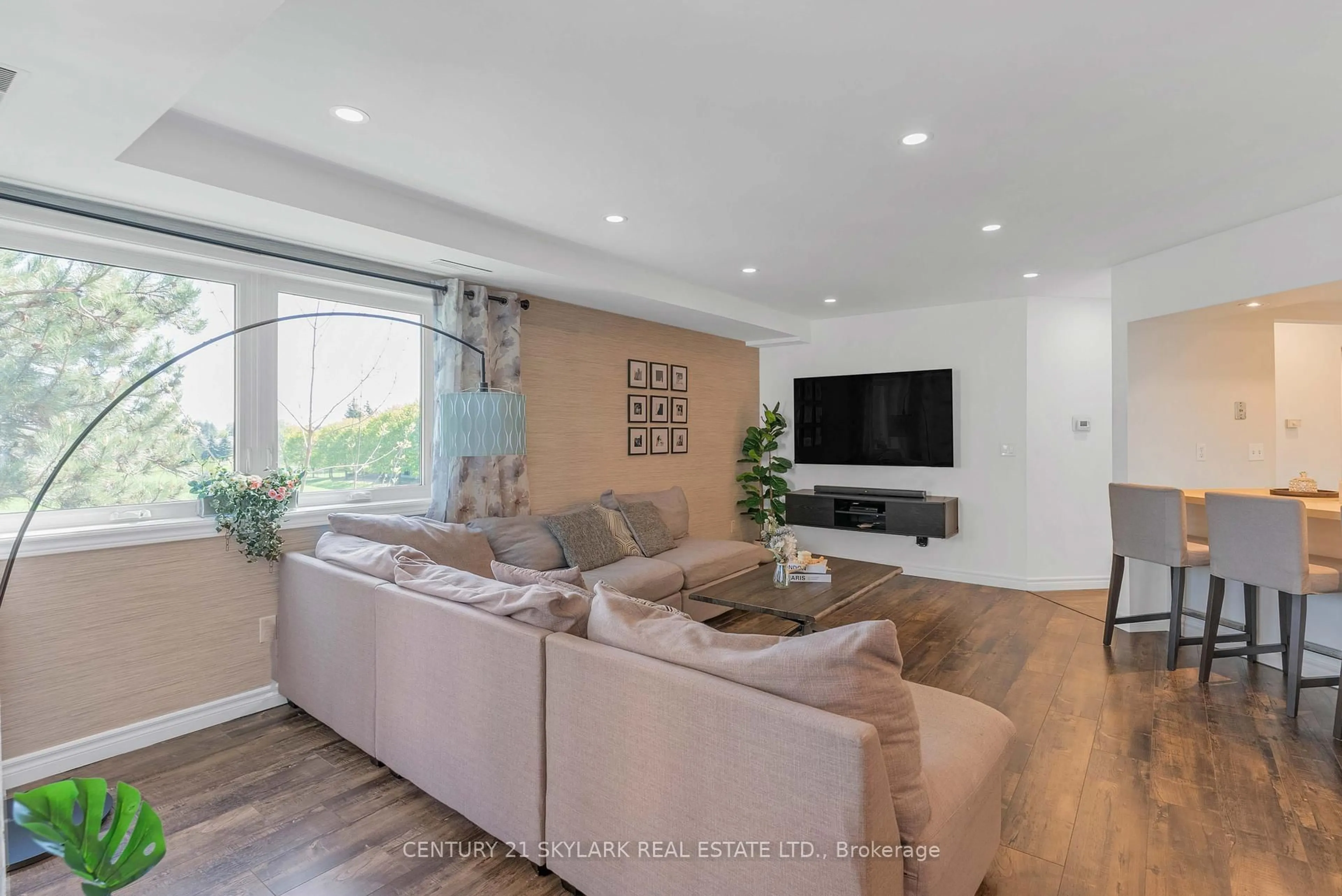Living room with furniture, wood/laminate floor for 55 Bristol Rd #102, Mississauga Ontario L4Z 3N9