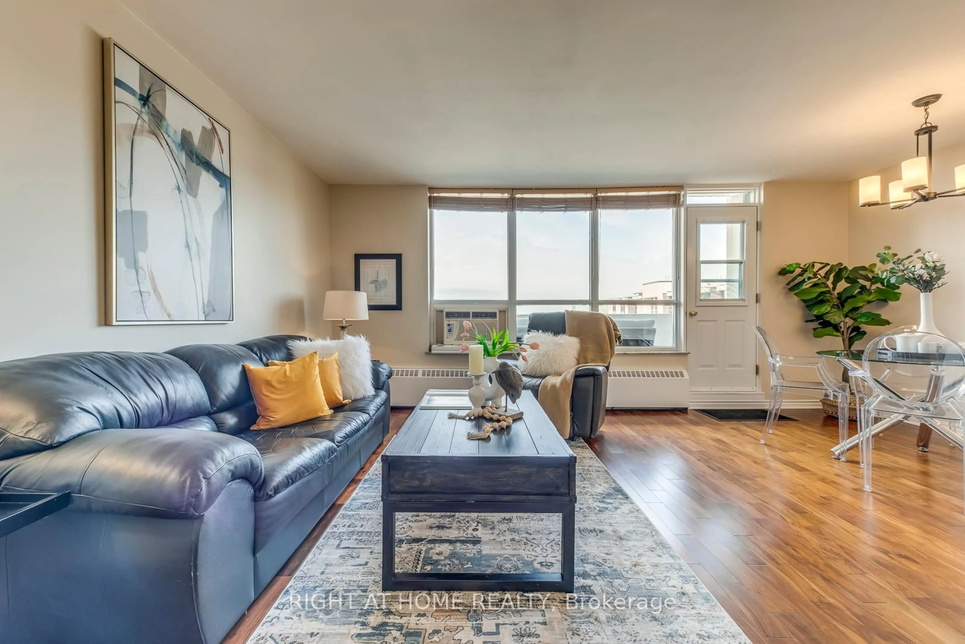 Living room with furniture, wood/laminate floor for 45 Southport St #PH11, Toronto Ontario M6S 3N5